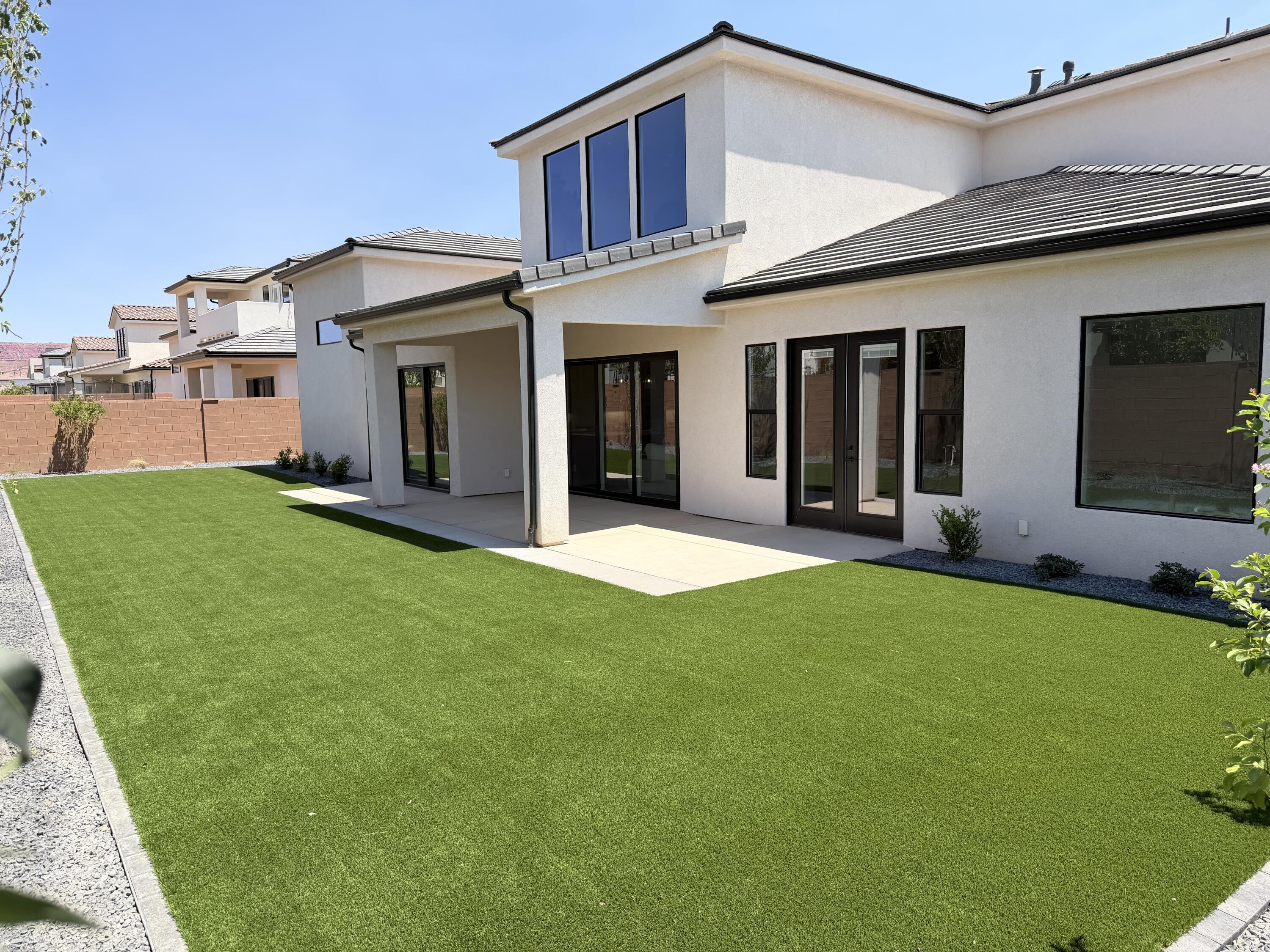 Brand-new and never lived in with No HOA! This thoughtfully designed home combines luxury finishes with practical upgrades already in place. Unlike many new construction homes, the backyard landscaping is complete and features maintenance-free synthetic grass, saving buyers both time and expense. The yard is also stubbed for a future pool, making it easy to create your ideal outdoor retreat.

Inside, a dramatic three-sided fireplace anchors the open-concept living area, while expansive sliding glass doors create seamless indoor-outdoor living. The private primary suite offers a spa-inspired bath, oversized custom closet with floor-to-ceiling cabinetry, and a convenient second laundry area.

The oversized 16' x 36.5' RV garage provides ample space for RVs, boats, and recreational vehicles, while additional side parking offers even more flexibility. Located on the Dixie Power grid near George Washington Academy and Crimson High School. No HOA.