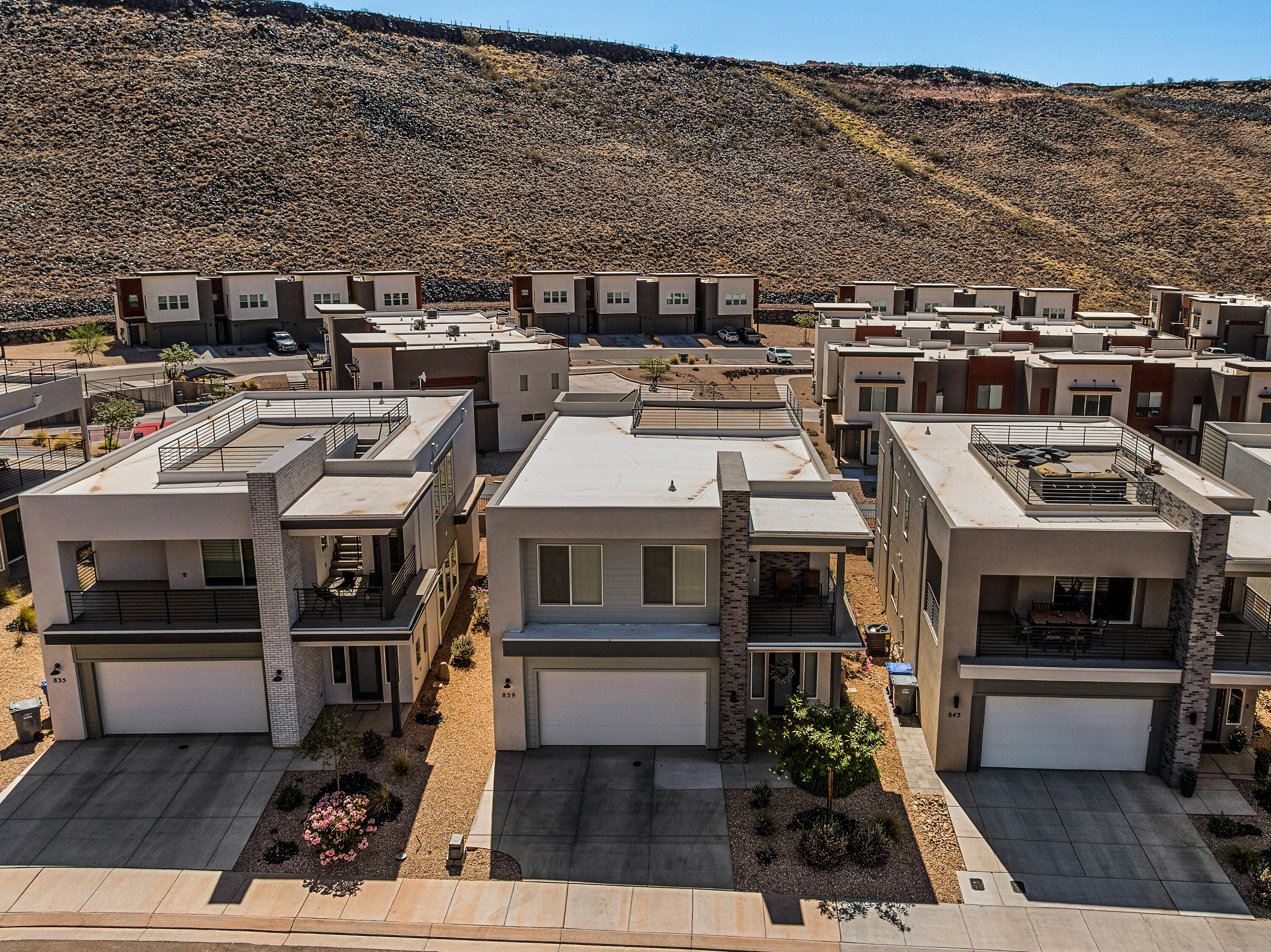Wake up to desert sunrises, spend your mornings on miles of paved walking and biking trails, challenge yourself on the nearby Dragontail Stairs, then unwind beneath a sky full of stars from your private rooftop deck. This is Southern Utah living at its best. Thoughtfully designed for both adventure and relaxation, the home offers bright, modern spaces and seamless indoor-outdoor living. The rooftop deck creates a rare extension of the home--perfect for entertaining, sunset gatherings, morning coffee, or simply soaking in the views. HOA amenities provide a resort-style lifestyle with a pool, hot tub, fitness center, pickleball courts, parks, playgrounds, and full yard maintenance, giving you more time to enjoy the things that matter most and less time worrying about upkeep. 3 bedrooms and a den make this home very livable.