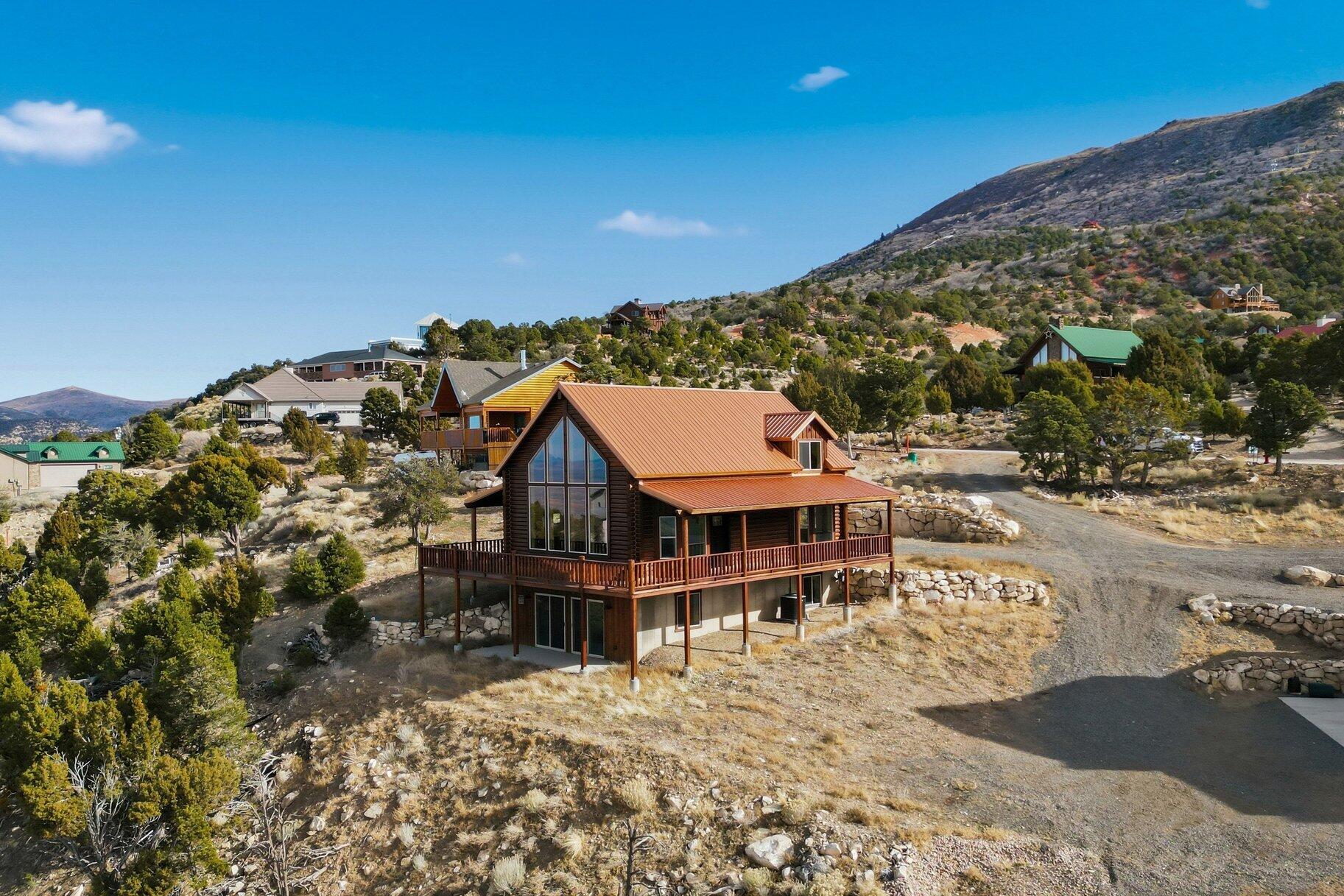 At just under 8,000 feet in the stunning subdivision of Cedar Highlands, this beautiful cabin offers all 2,400 sqft of living space across 3 levels. Enjoy the expansive breathtaking views of the Cedar City Valley in the large living room with 20' ceilings. This chalet-style cabin has panoramic mountain and valley views that can be taken in from the large semi-wrap around covered porch with an acre of land perfect to add a detached garage. The cabin features 3 bedrooms, 3 baths, large windows, vaulted ceilings, granite countertops, fireplace, large loft with ensuite, and wood burning stove. The basement offers a large open space with a fireplace, sliding doors, and plenty of closet space. Just over 2 hours from Las Vegas, and at almost 6,000 feet of elevation, Cedar City is one of the most beautiful cities in Southern Utah. It is home to Southern Utah University and the Shakespeare Festival, as well as amazing restaurants. As part of Southern Utah, you will experience a lifestyle like no other. The area features nearby internationally recognized mountain biking trails, road cycling, hiking, golf courses, national parks such as the Grand Canyon, Zion, & Bryce, national moments, national forest, reservoirs, & some of the most iconic desert landscape in the world. Less than hour away from Brian Head Ski Resort, there is no doubt that this is a fun place to live and play.((All information herein is deemed reliable but is not guaranteed. Buyer is responsible to verify all listing information, including square feet/acreage, to buyer's own satisfaction.