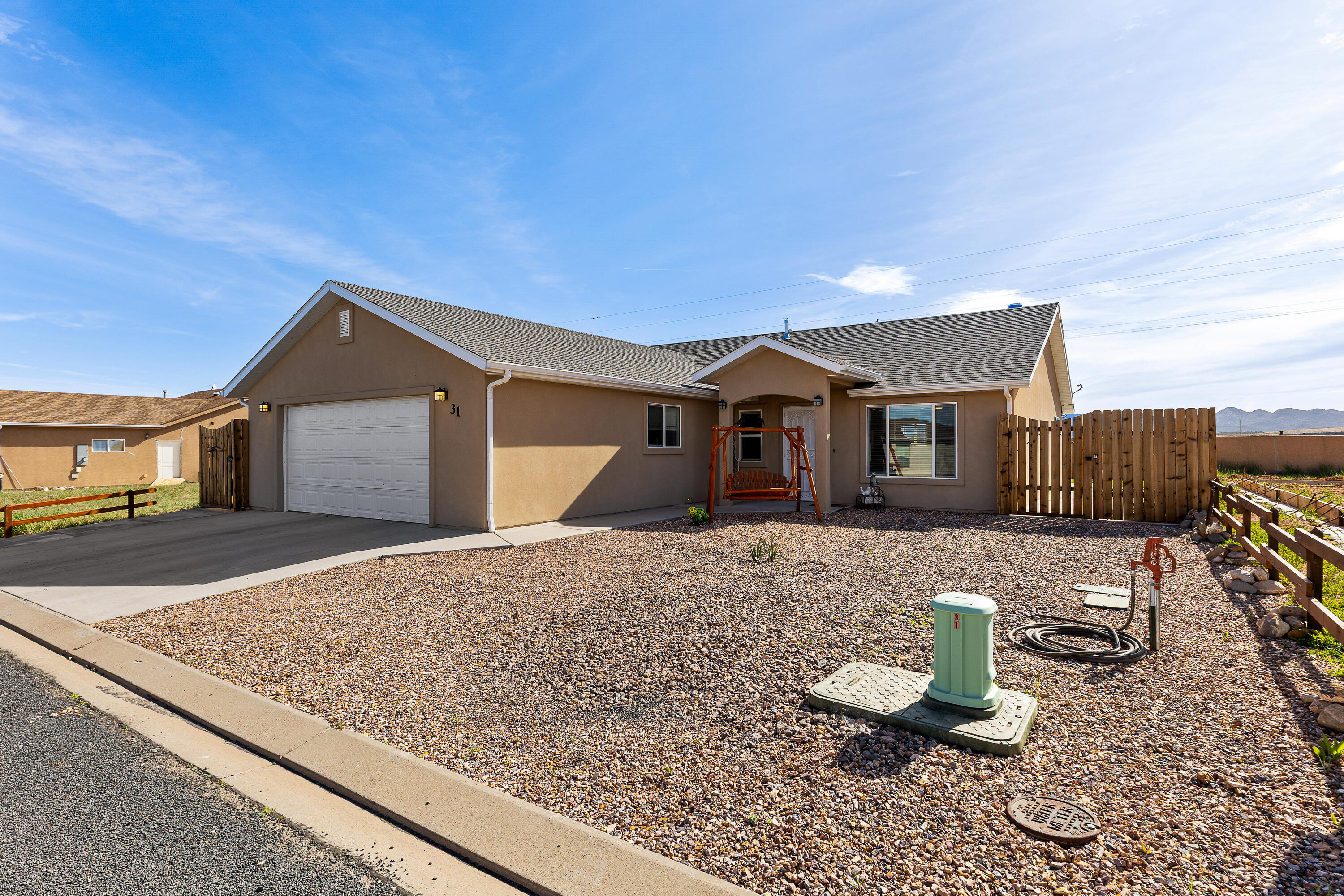 Best-priced single-family home in Enterprise! Built in 2019, this 1,496 sq ft home offers 3 bed, 2 bath on a 0.13-acre lot. Features include an extra-large 576 sq ft 2-car garage, can lighting, ceiling fans, and a rare oversized pantry with sink. Open, functional layout with great natural light. Fully fenced with easy-maintenance desert landscaping in front and grass in back, plus a storage shed. Enjoy beautiful views of the eastern mountains from the backyard. No HOA or transfer fees. Located in a quiet neighborhood with true small-town charm. Enterprise offers parks, pond, community center, grocery, pharmacy, gas, restaurants, schools, and medical services. Just 40 minutes to St. George or Cedar City. Great primary home, second home, or investment opportunity!