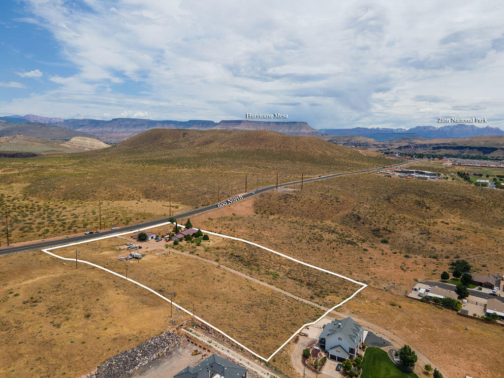 Attention Developers!! Don't miss this incredible development opportunity for a mixed-use development on just under13 acres on Hurricane's Prime Commercial Corridor, 600 North.  
This 5.46 acre portion just received a re-zone to Planned Commercial. The town approved of a mixed use of 67% commercial and 33% residential use. Combine it with the two properties next door and create a one-of-a-kind destination with both commercial and multi-housing residential projects. Additionally, the proximity to two other available and adjacent parcels opens up the potential for a mixed-use development spanning nearly 13 acres. 
 Current Zoning allows for retail spaces, restaurants, hotels, bed and breakfast Inn's, and more!
The land comes with the bonus of an existing 1907 sq ft home which features 3 bedrooms, 2.5 bathrooms, a spacious kitchen, ample living area, an 1858 sq. ft garage and stunning outdoor spaces. The surrounding landscape is picturesque with scenic views and mature trees. The property's location and size make this a unique opportunity to bring a creative new development to the Town of Hurricane. Please call to discuss the utilities and access information for this whole development possibility.
SELLER FINANCING AVAILABLE!!