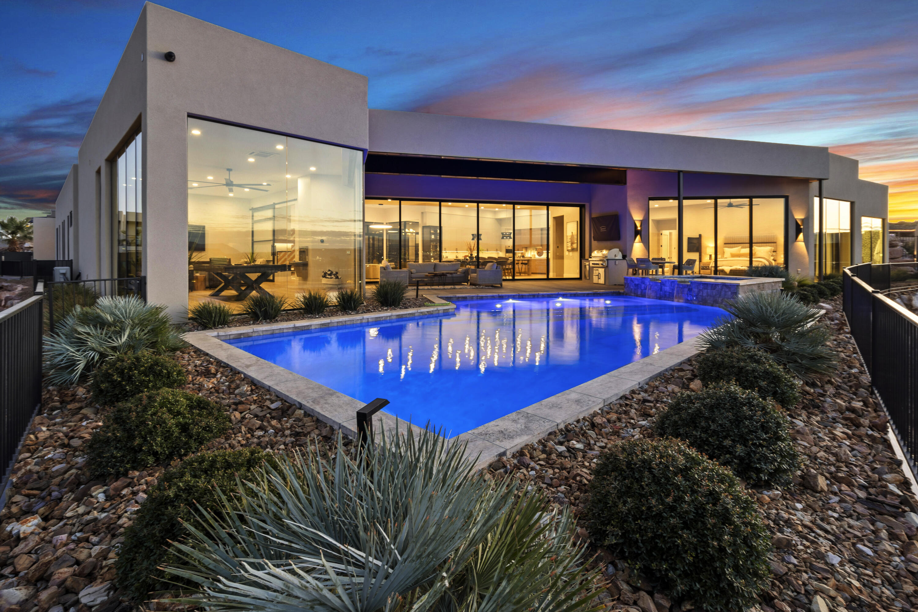 2022 Parade Home built by Anderson Custom Homes. ***Price includes all furniture & decor*** 6,704 sq/ft all on 1 level. No upgrade was overlooked in this one of a kind Stone Cliff Masterpiece. Unprecedented views framed with 14 ft ceilings & spacious open-concept floor plan with inviting earth tones. The 31 ft collapsible glass doors in living area invite the outdoors in & showcase the sweeping views of Pine Valley Mtn & the city below. The climate controlled RV garage will fit all of your toys. The gourmet kitchen features SubZero/Wolf appliances, steam oven, drink fridge and more. Control 4 full home automation (this home is super hi-tech and can be controlled from a smart phone/tablet). Automatic window coverings, misting system and much more.

Massive kitchen with Wolf & Subzero appliances & custom cabinetry. Oversized granite islands give plenty of prep space & seating to accommodate any size of gathering.

2,440 sqft of garage space include a 50 ft deep double wide RV with an 14ft high door for all the toys. Explore hobbies & have plenty of storage in this conditioned space.

Flex room has floor-to-ceiling windows, TV & sound system, & separation from the main area of the home.

Master bed & bath offer privacy & views at every turn. Large windows let in plenty of light. Step into the large walk-in-closet & never run out of storage again.

Large guest suites are located on the opposite side of the master allowing privacy & comfort for guests & owners. All bedrooms have their own bathroom ensuite & style.

Outdoor living area faces north so it may be enjoyed year round. Covered patio space galore. Low maintenance landscaping & outdoor lighting will make this property glow at night. Plunge into the refreshing pool & relax in the hot tub while taking in the view. Built-in BBQ & outdoor sound system make this space perfect for any get together.