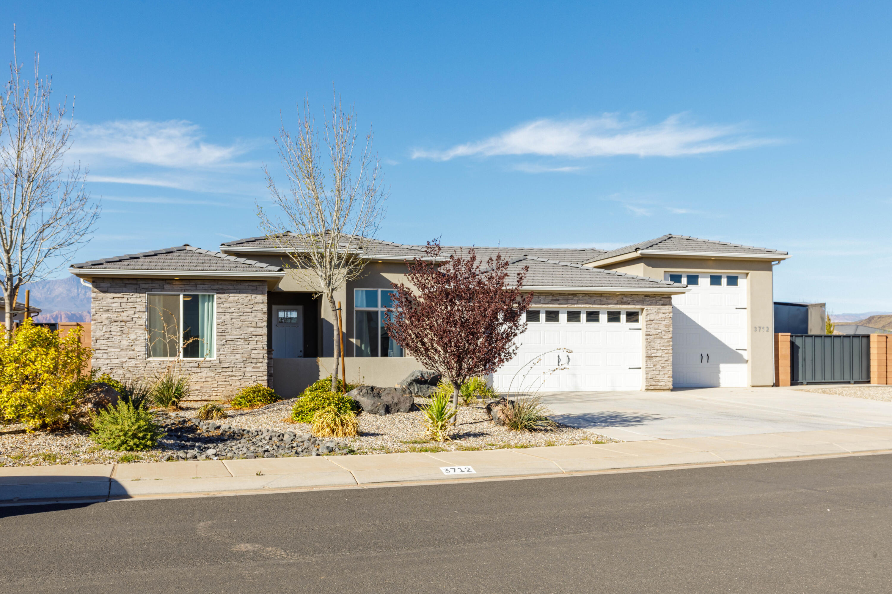 Rare 31' pull-through RV garage with 2 10'x12' doors on each side of garage, street access from back yard/side street, Plus paved RV parking on the side of the home, complete with 2 240V outlets, climate control, and epoxy floors. Perfect for storing all your toys and adventure gear. Extra storage above 2 bay garage. The property also includes gated access from the backyard to the street behind the lot, adding extra convenience for parking, access, or storing recreation vehicles.

Inside you'll find quality finishes and a functional layout, including 11' ceilings in living area, 9' ceilings in bedrooms, wide plank tile flooring, spacious room sizes, and a desirable split floor plan offering privacy and comfortable living. The kitchen features a built-in range, RO water system, custom hood, and hidden pantry for a clean, modern look with great storage.

The primary bathroom offers flexibility with a large shower and room to add a vanity or tub of your choice. Enjoy views of Pine Valley Mountain from the large covered patio, perfect for relaxing in the shade and watching the sunset.

Another benefit of living in Dixie Springs is power through Dixie Power, known for some of the lowest electricity rates in the nation.