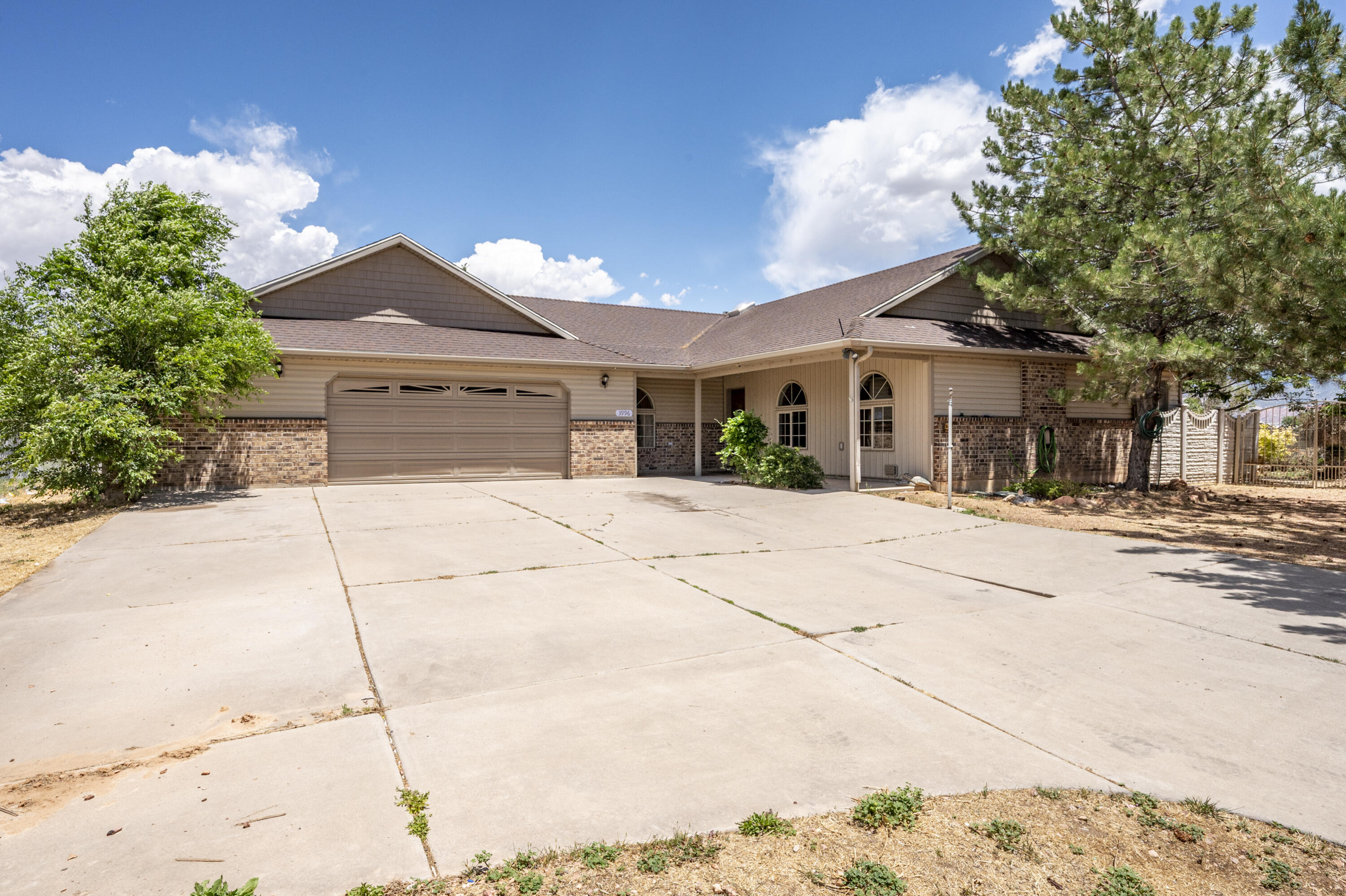 Welcome to 3996 W 250 N in Cedar City, Utah! This well-maintained 4 bed, 2 bath home offers 2,016 sq ft of comfortable living space on a spacious quarter-acre lot in a quiet cul-de-sac. Inside you'll find vaulted ceilings, large windows, an open floor plan, and a cozy fireplace that creates a warm and inviting atmosphere. The kitchen features beautiful wood cabinetry, skylights, and plenty of counter space. The oversized garage includes built-in storage cabinets, while the backyard offers mature trees, a private patio, and incredible mountain and valley views. Conveniently located within walking distance to Iron Springs Elementary and close to Cedar City amenities.