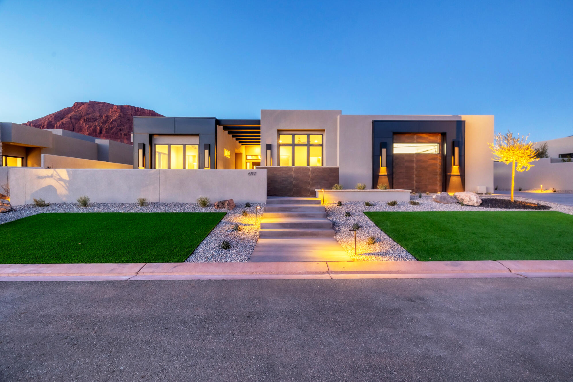 Welcome to your dream oasis nestled in the heart of Ivins! This new construction home is amongst the final gems to be built in The Palisades at Snow Canyon. Boasting a stunning desert contemporary design and top-tier finishes, this 3-bedroom plus den, 3.5-bathroom home offers jaw-dropping views of Red Mountain and The Vermillion Cliffs, especially from the rooftop patio! The master suite with a custom sauna welcomes you everyday.  Need an RV Garage?  This home has one with a 12 foot tall garage door and over 1250 square feet of garage space.  Imagine lounging by an incredible private pool, warmed by dancing fire features—sounds like a permanent vacation, right? As part of a gated community, enjoy access to a clubhouse, pool, spa, and an exercise room, not to mention 5 pickleball courts, a tennis court, and a basketball court. Plus, forget lawn care; it's all handled by the homeowners association. Whether you're pickleball pro or a relaxation enthusiast, this home checks all the boxes for a blissful lifestyle. Welcome home to luxury living at its finest!