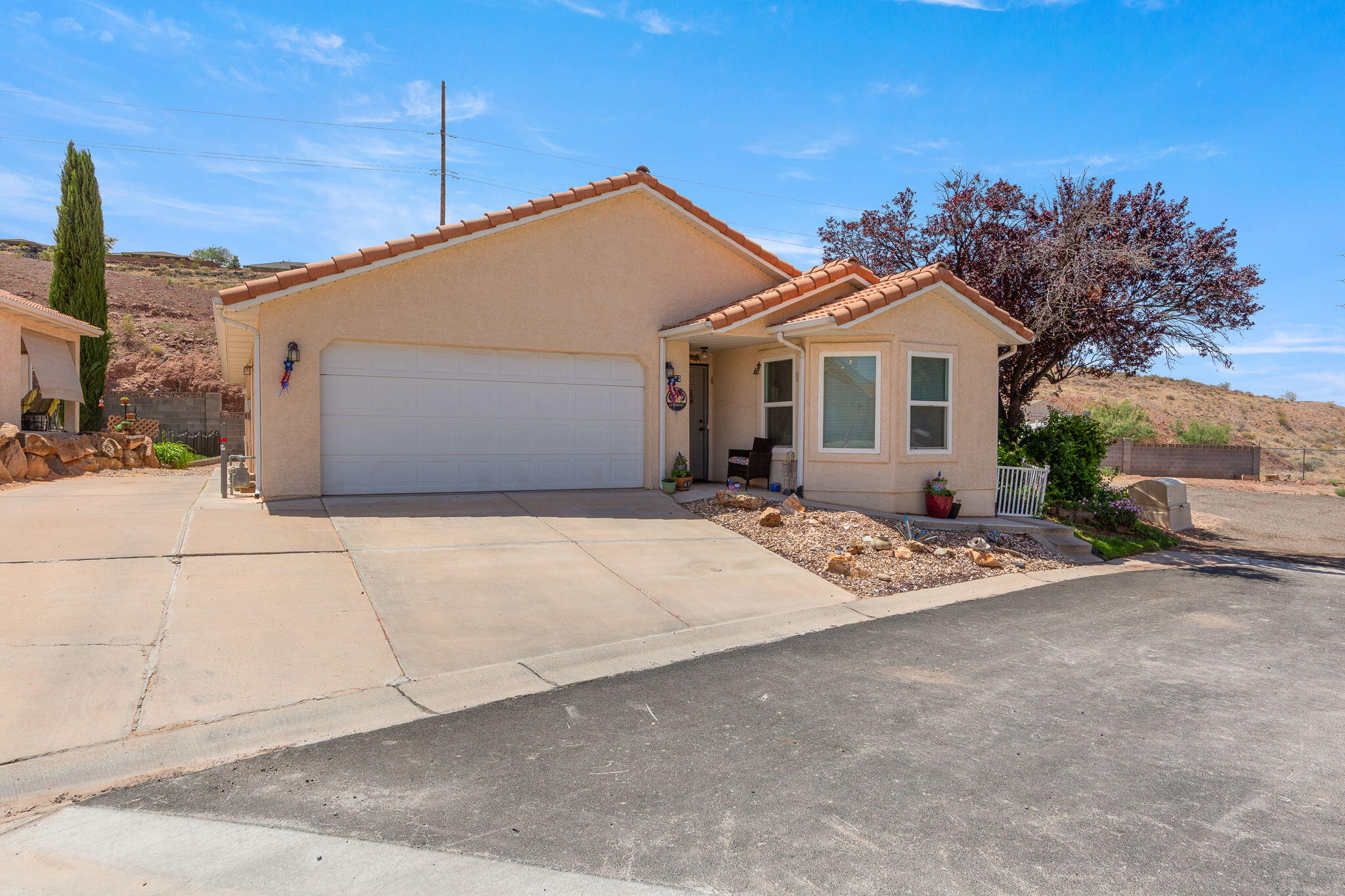 Tour the largest lot in the community with beautiful valley views from the back patio! This inviting home is ideal as a full-time residence or the perfect second home. Located in a desirable 55+ community, the home features a spacious living room, 2-car garage, and additional parking for guests. The oversized patio creates the perfect setting for morning coffee, entertaining, or relaxing evenings while enjoying the propane fire place while taking in the scenery. Conveniently situated near shopping, dining, and everyday amenities, with an affordable HOA that makes for easy, low-maintenance living. Don't miss this rare opportunity to own one of the premier lots in the community! Garden Boxes are included.