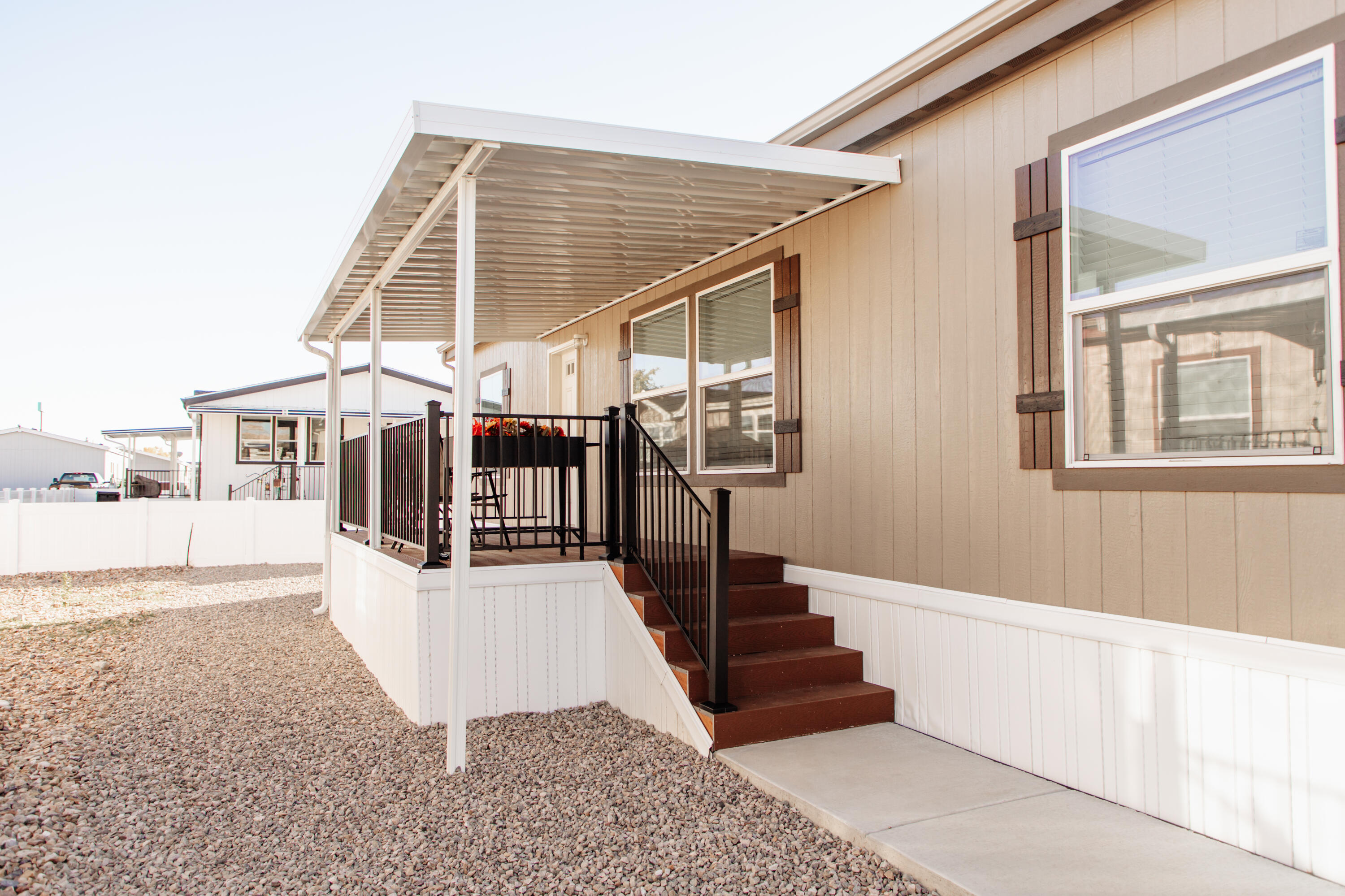 Move-in Ready! Beautiful, energy star efficient manufactured home in Pleasant View. Like new—only one owner! Modern design with an oversized 2-car carport,  and a spacious covered deck.
Open floor plan with tall ceilings, bright living room, and a chef's kitchen featuring a large island, gas range, subway tile, farmhouse sink, and an expansive wraparound pantry. Primary suite includes a walk-in closet with built-ins and a private bath with soaker tub and custom vanity. Home also offers a large laundry/mudroom, two additional bedrooms, and a full modern bath. Plus, a whole house surge protector has been installed.
Conveniently located near shopping, dining, and I-15. Water, sewer, and trash paid to the park; gas and electricity paid to utility providers. Beautiful community with basketball court, playground, and pickleball court. New pool and clubhouse coming soon.
Buyer will save thousands by getting a home with a carport, covered deck and yard installed as required by the community.
The Seller requests 1 ½ hour notice prior to showing on weekdays and 30 minute notice on weekends.
Must be pre-approved by the park before submitting an offer. Park approval requires applications for all residents 18+, $50 per application, background check, and income of 3x lot rent. Contact park for timelines and confirmation.
Buyer and buyer's agent to verify all information. Square footage provided as a courtesybuyer to obtain independent measurement. Schedule your private showing today!