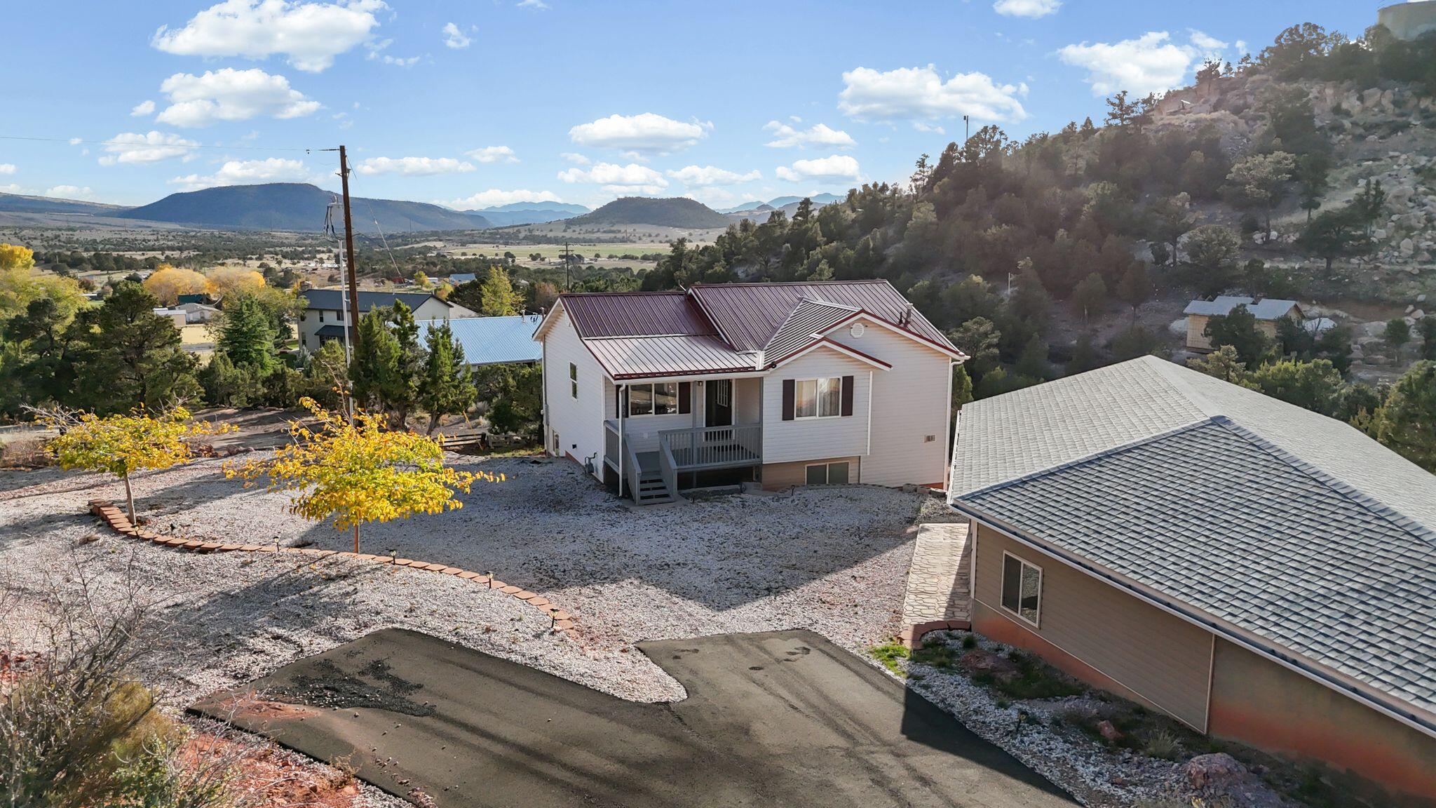 Prestigious location near some of Southern Utah's most incredible outdoor recreation, including Zion National Park, multiple state parks, and six nearby lakes known for fishing, boating, and wakeboarding. This property is a dream for outdoor enthusiasts looking to escape the city and enjoy cooler mountain air, peaceful surroundings, incredible star-filled nights, and breathtaking mountain and countryside views. Start your mornings on the back deck enjoying breakfast while watching wildlife such as wild turkey and deer wander through the area. Ride four-wheelers or dirt bikes on and off the property with access to endless nearby trails and outdoor adventure. Spend your days hiking scenic cliffs, exploring famous destinations like Angels Landing and The Narrows in Zions National Park, or discovering petroglyphs and unique rock formations throughout Southern Utah. After a full day of adventure, come home to a comfortable property with plenty of room for friends, family, toys, and gatherings. Located approximately 10 degrees cooler than St. George during the summer months, this mountain-area retreat offers the perfect balance of recreation, comfort, and peaceful living. Discover this spacious 5-bedroom, 3-bath home in the peaceful community of Central, Utah. Situated on .63 acres at the end of a quiet cul-de-sac, this 2,096 sq ft split-level home offers privacy, usable space, and incredible views of the surrounding mountains and farmland below. Recent upgrades include a new roof and new asphalt driveway. Inside, you'll find two comfortable living areas, a functional layout, and access to a large deck off the kitchen--perfect for barbecuing, entertaining, or simply enjoying the peaceful setting and beautiful scenery.

The oversized detached 1,054 sq ft garage offers room for two vehicles plus a boat, toys, workshop space, or additional storage. There is also dedicated shop space in both the basement and garage areas. Special bonus: a large gun safe is included with the home. The property is ATV and dirt bike friendly, making this a true outdoor recreation paradise. The hillside portion of the property offers additional possibilities for four-wheeling, planting an orchard or vineyard, or creating your own outdoor retreat.

Want even more space or a future building opportunity? The neighboring lot is also available for purchase. This is a rare opportunity to own a peaceful Southern Utah property built for adventure, recreation, and gathering with family and friends.

Home is located just of highway 18. It is about 30 minutes to either St George or Cedar City.  It is not as cold as Cedar City in winter and not as hot as Saint George in the hot part of summer.