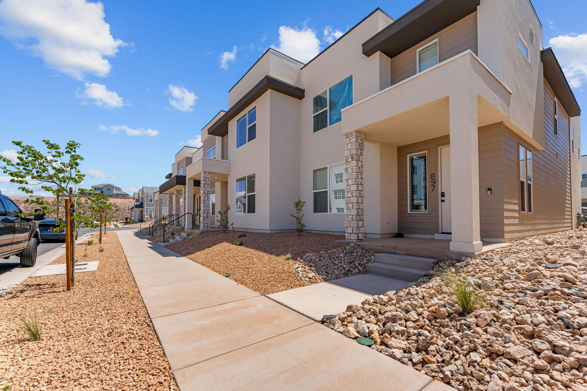 897 and 895 are connected and being sold together or separate. Pictures of this unit are of 895 as they're identical. Current lease is in place until 2/26/27 @ $2100 per month. End unit includes Fridge, washer, dryer, water softener and window coverings included. These large spacious floor plans offer a family room up and another down. Bedrooms are large with custom tiled shower and double sinks in the primary. Quartz tops throughout with warm LPV floors throughout the main level.  Enjoy all the benefits of Desert Color while enjoying the seclusion of this incredible location.