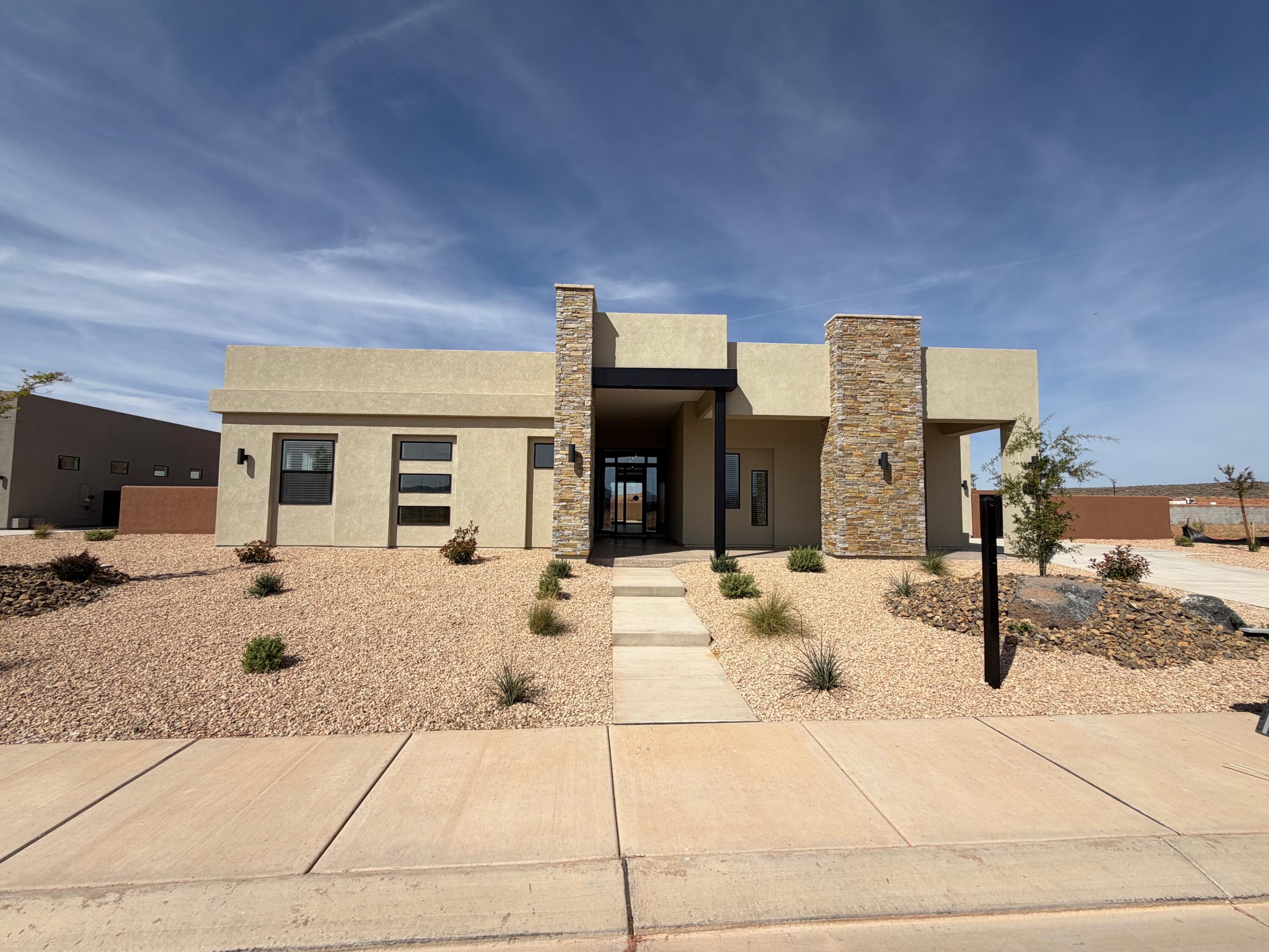 Discover luxury desert living in the prestigious Estates at Sand Hollow. Located at 3322 Guide Star Way, this move-in-ready Aspen plan from Carefree Homes' Luxe Collection offers an exceptional combination of quality craftsmanship, modern design, and resort-style amenities.

Featuring 2,619 square feet, 4 bedrooms, and 3.5 bathrooms, this thoughtfully designed home boasts an open-concept floor plan that seamlessly blends comfort and functionality. The gourmet kitchen flows effortlessly into the spacious great room, while retractable floor-to-ceiling glass patio doors create a true indoor-outdoor living experience, perfect for enjoying Southern Utah's year-round sunshine.

The luxurious primary suite provides a private retreat, complemented by premium finishes throughout including 10-foot ceilings, 8-foot doors, upgraded luxury vinyl plank flooring, and pre-wiring for four zones of surround sound. Built with energy-efficient 2x6 construction, this home delivers both quality and lasting value.

A standout feature is the oversized 40-foot RV garage complete with epoxy floors and Carefree Homes' signature built-in shelving, offering ample space for recreational vehicles, toys, and storage. The professionally completed 360-degree low-maintenance landscaping and included window coverings make this home truly turnkey.

Enjoy the unparalleled lifestyle of Sand Hollow with HOA amenities that include access to resort facilities, discounted golf rates, and exclusive community events. For those seeking the ultimate backyard oasis, the builder can add a custom pool at closing for approximately $150,000, with completion anticipated within 90 days after closing. Contact the listing agent for details and available pool options.