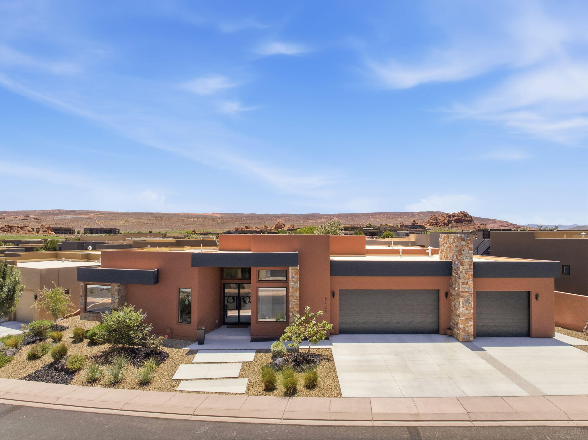 Welcome to this exceptional custom home by JMR Design & Construction in Dunes at Sand Hollow Resort. This beautifully designed single-level home offers 4 bedrooms, 3.5 bathrooms, and a spacious 3-car garage with stunning architectural details throughout. The open-concept floor plan features soaring ceilings, luxury vinyl plank flooring, granite countertops, custom finishes, and a gourmet kitchen. The private primary suite offers direct patio access, while the fourth bedroom showcases mountain views through a unique box bay window with a built-in window seat. Enjoy year-round outdoor living on the covered concrete patio complete with built-in lighting, gas hookups, multiple electrical outlets, mature landscaping, and a Rain Bird irrigation system. Additional features include zoned HVAC, washer, dryer, and refrigerator are included, plus a low perimeter wall for added privacy. HOA covers full private yard care as well as full common area maintenance. Located just minutes from Sand Hollow Reservoir, Quail Lake, championship golf, sand dunes, hiking, shopping, and more! Residents also enjoy access to three resort pools, a hot tub, fitness center, driving range, a 40% golf discount, and a full-service clubhouse restaurant with incredible views. Luxury living meets adventure in one of Southern Utah's premier resort communities.