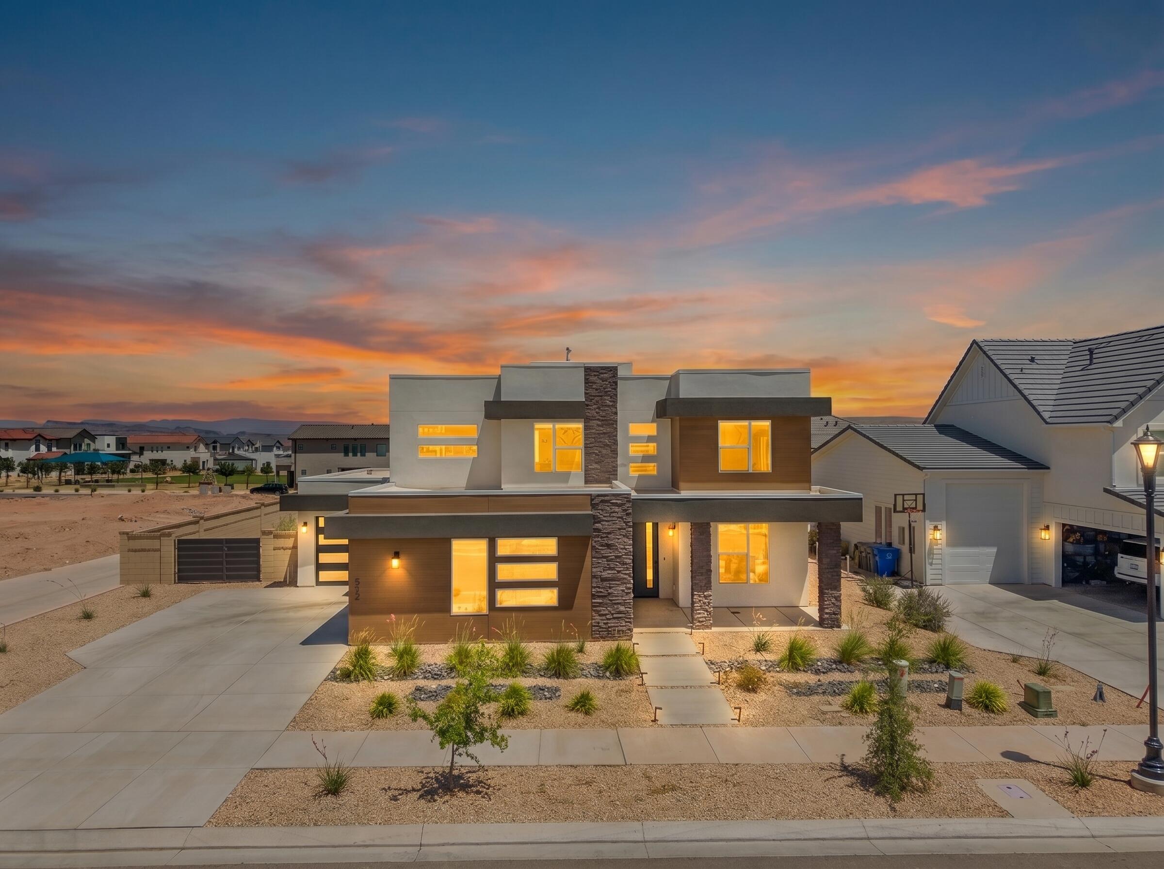 One of the most upgraded homes in Desert Color, this better-than-new modern residence offers 4 bedrooms, 2.5 baths, a dedicated office, spacious loft, and over $100,000 in designer upgrades. Situated on an oversized corner lot just steps from the new resident-only pool, this rare floor plan combines a custom-home feel with one of the largest backyards in the community--offering room for a pool, pickleball court, hot tub and more.
Blending indoor and outdoor living, expansive sliding doors open to an extended patio with two gas hookups for a future fireplace and outdoor kitchen--perfect for entertaining.
Enjoy elevated finishes throughout, including premium two-tone hardwood flooring, Quartz Contertops, upgraded 8-foot interior doors, a gourmet kitchen, and a stunning 50'' electric fireplace. The spa-inspired primary suite and 3-car insulated garage add to the home's thoughtful design and functionality. All just moments from Desert Color's renowned 2.5-acre lagoon, pickleball courts, trails, and resort-style amenities