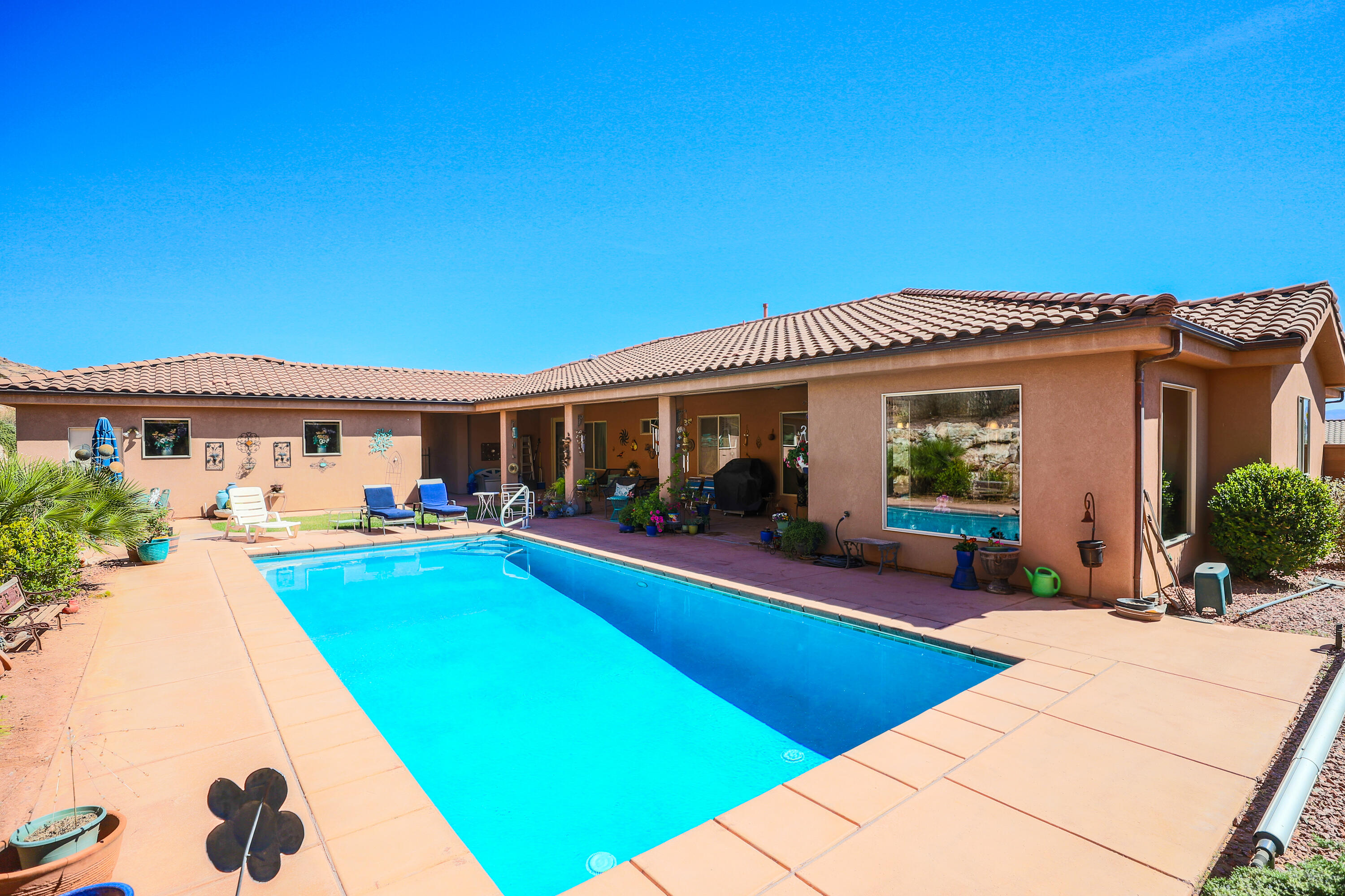 Beautiful Custom built home situated on a spacious .63 acre lot in one of Southern Utah's most sought-after neighborhoods. Enjoy privacy and open views with no neighbors behind, creating the perfect backyard retreat. The property features a stunning pool, ideal for relaxing or entertaining while taking in the peaceful surroundings. Inside, the thoughtfully designed single-level layout offers comfortable living and easy flow throughout. Plenty of space both inside and out with room to enjoy and includes RV parking. Conveniently located just minutes from shopping, dining, and scenic hiking and biking trails, this home combines privacy, space, and accessibility in a great location with no HOA.