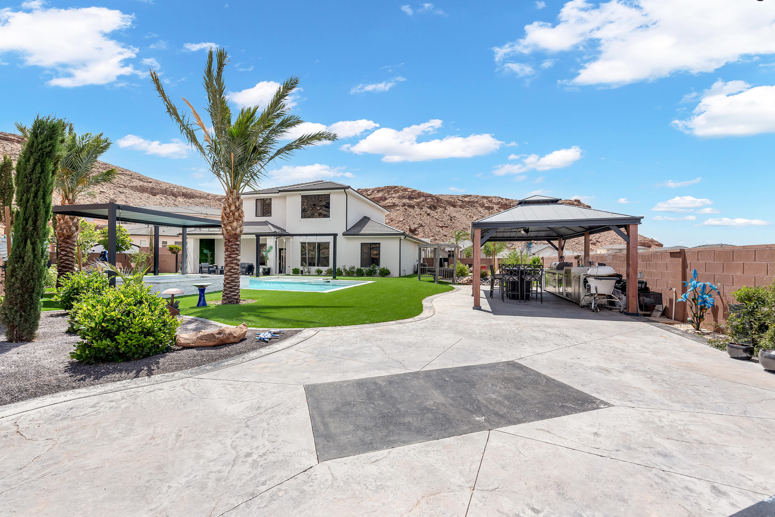 One of the best backyard is all of St. George! This Desert Canyon home sits on a huge .37 acre backing the canyon and thousands of miles of Arizona recreation land. This home features an unforgettable yard with custom built pool featuring waterfalls, shamoo shelf and oversized hottub, an outdoor kitchen and gazeebo, firepit and putting green. Inside the home is beyond comfortable with a state of the art cinema, multiple upstairs and downstairs bedrooms and bathrooms, premium fireplace and so much more. Book a showing today!