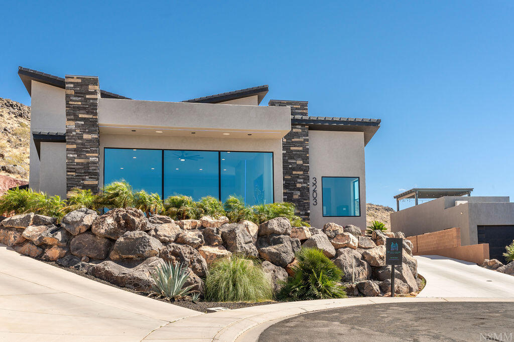 DESERT MODERN MASTERPIECE WITH PANORAMIC VIEWS. Experience the pinnacle of contemporary luxury in this custom designed architectural marvel. Perched high to command breathtaking, unobstructed views, this estate blends dramatic modern design with functional, high-end living. Resort style bathrooms with jaw dropping walk in showers.  The homes exterior showcases a beautiful mix of warm desert stucco, clean architectural overhangs with integrated lighting, and massive stacked-stone pillars. This is more than a home: it's a design forward lifestyle statement. Perfect for the buyer who demands bold architecture, premium finishes, and unparalleled views.
The back yard and RV Garage have renderings available or it can be completed to your clients wants and needs.
OWNER AGENT!!!!