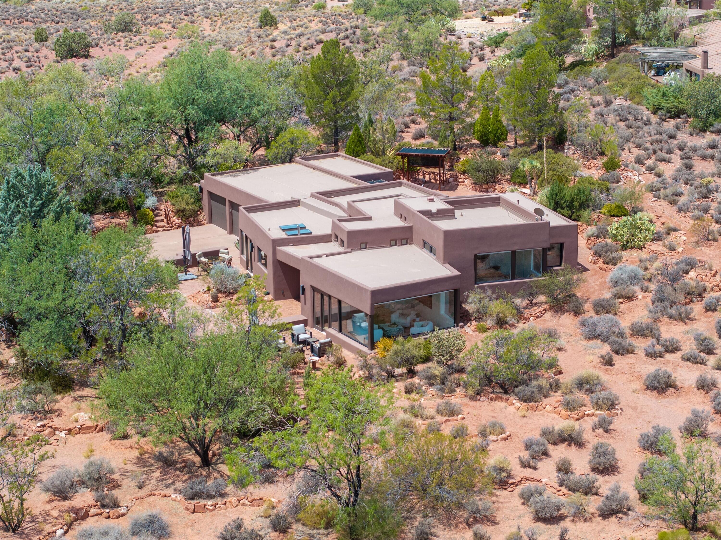 Completely renovated from top to bottom in 2025, this timeless Kayenta residence seamlessly blends classic architecture with sophisticated modern design. Ideally located in the heart of the community, the home is just a short distance from the renowned Kayenta Art Village, where exceptional dining, boutique shopping, art galleries, recreation, and cultural experiences await.

Originally built in 1992, this beautifully reimagined home sits on a private 0.54-acre lot surrounded by mature desert landscaping and framed by breathtaking views of Kayenta's iconic red rock cliffs. The serene setting offers an exceptional sense of privacy while embracing the natural beauty that defines Southern Utah.

Designed with both comfort and functionality in mind, the thoughtfully updated floor plan features three spacious bedrooms, two and one-half bathrooms, a formal living room, and an expansive family room or den that's perfect for entertaining, relaxing, or working from home. The open-concept kitchen is a showpiece, featuring new custom cabinetry, premium countertops, and brand-new Bosch appliances, including an induction cooktop, creating a space that is as beautiful as it is functional.

The three-car garage includes a climate-controlled flex room that can easily serve as a home gym, art studio, yoga retreat, workshop, hobby room, or additional creative space.

Every major system and finish has been meticulously updated during the comprehensive 2025 renovation. Improvements include new HVAC, electrical, hot water heater, a water softening system, a new roof membrane, fresh stucco, updated exterior lighting, and upgraded irrigation valves and sprinkler heads. Inside, virtually every surface has been transformed with new hardwood flooring throughout the kitchen and living areas, plush carpeting in the bedrooms, fresh interior paint, custom cabinetry in the kitchen and bathrooms, premium countertops throughout, new plumbing fixtures, updated electrical wiring, recessed lighting, designer tile work, new front and interior doors, oversized butt-glazed living room windows that beautifully frame the surrounding red rock vistas, expansive glass sliding doors, two new kitchen skylights, a new washer and dryer, epoxy-coated garage floors, and countless additional upgrades.
Offering spectacular views, exceptional craftsmanship, and an unbeatable location in one of Southern Utah's most sought-after communities, this is a rare opportunity to own a truly turnkey home and experience the very best of the Kayenta lifestyle.