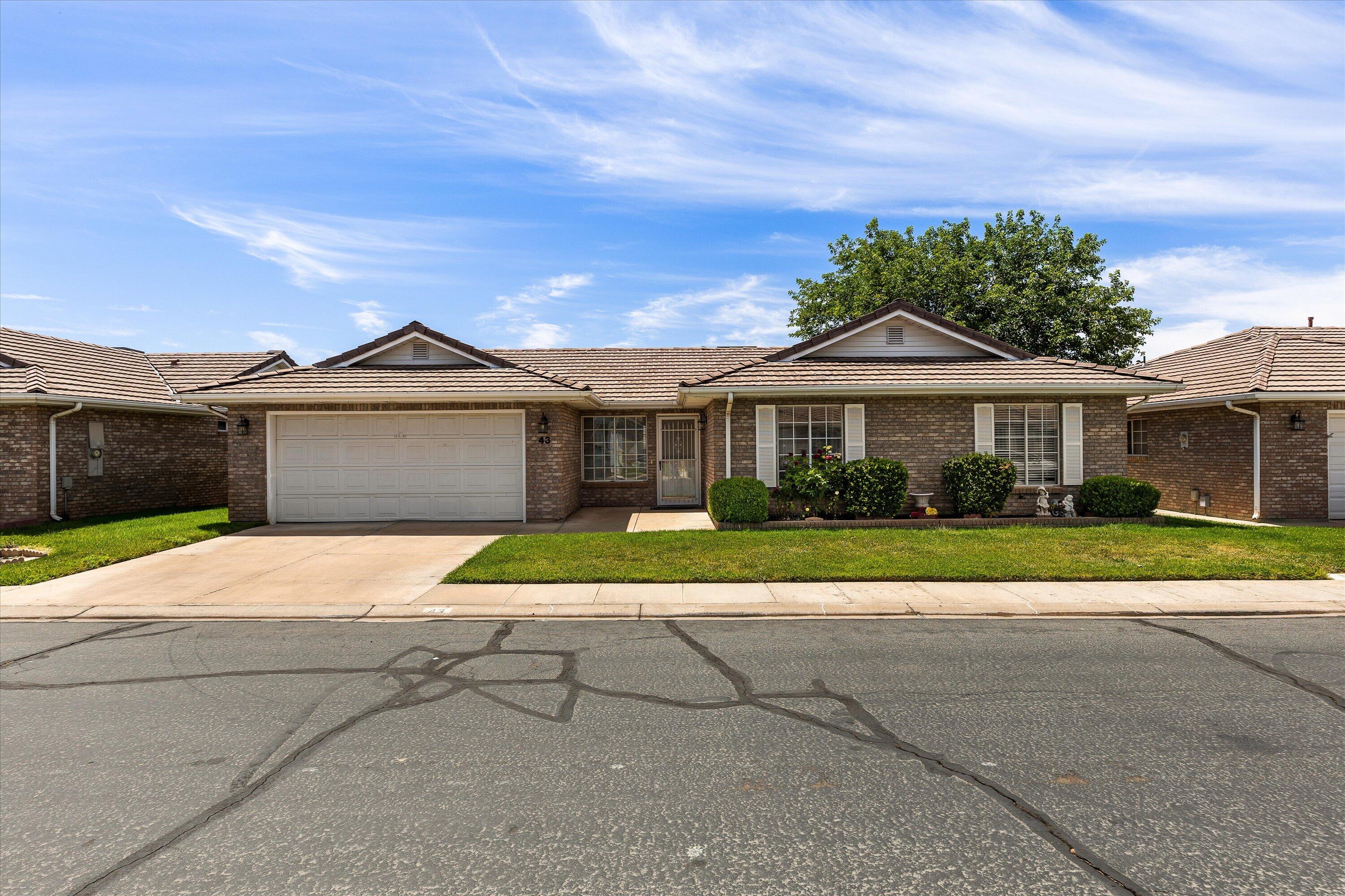 Welcome to Sun Country Meadows South, one of St. George's premier 55+ communities! This well-maintained single-level home offers 3 bedrooms, 2 bathrooms, and a 2-car garage with no stairs. Built in 1991 with quality brick construction and a durable tile roof, it features a comfortable floor plan and a primary suite with a walk-in shower. Enjoy exceptional community amenities including a clubhouse, indoor pool and hot tub, fitness center, billiards room, library, kitchen, dining and dance hall, family gathering areas, and a scenic pond with ducks. HOA is $240/month and includes water, sewer, garbage, private roads, partial yard maintenance, common area maintenance, and full access to amenities. Conveniently located near the hospital, shopping, dining, and everyday services.