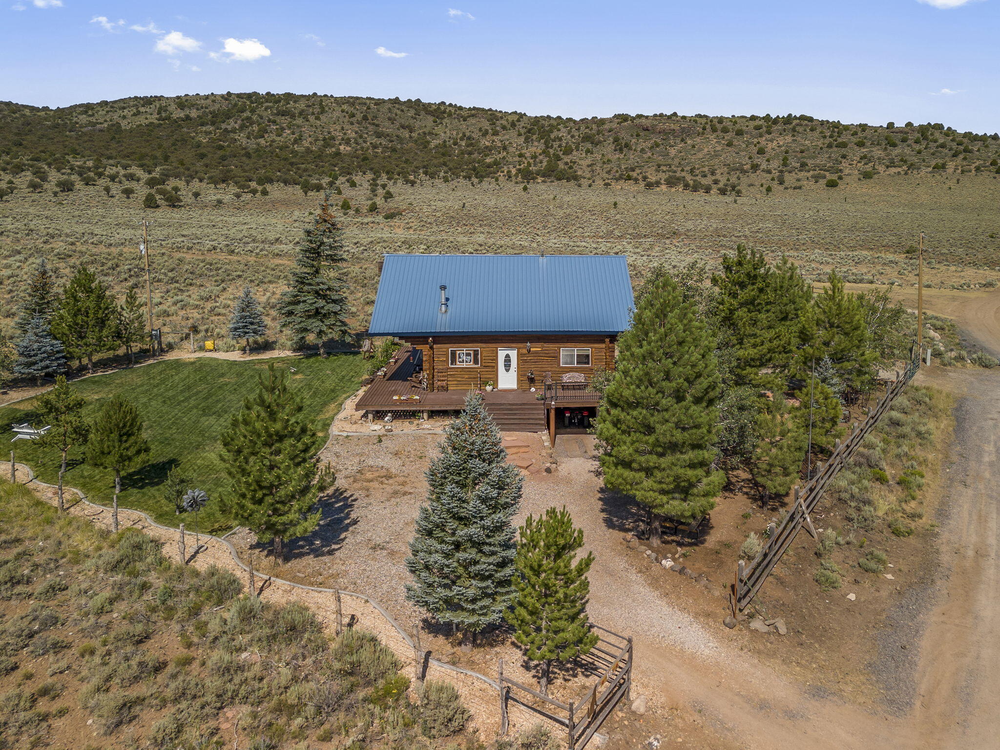This amazing view comes with a cabin!! You wont' believe how peaceful, serene and quaint this fantastic 2 bedroom, 1 bathroom log cabin really is.  Located in Pine Valley Ranchos. Backs to forestry land with gated access for off road adventures. Space under the cabin will hold Off Road vehicles and has a built in work shop. Decks on three sides.  Come take a look, sit on the front deck and smell the trees, take in the fresh mountain air and relax.  Great for a 2nd home, family retreat or full time living.
