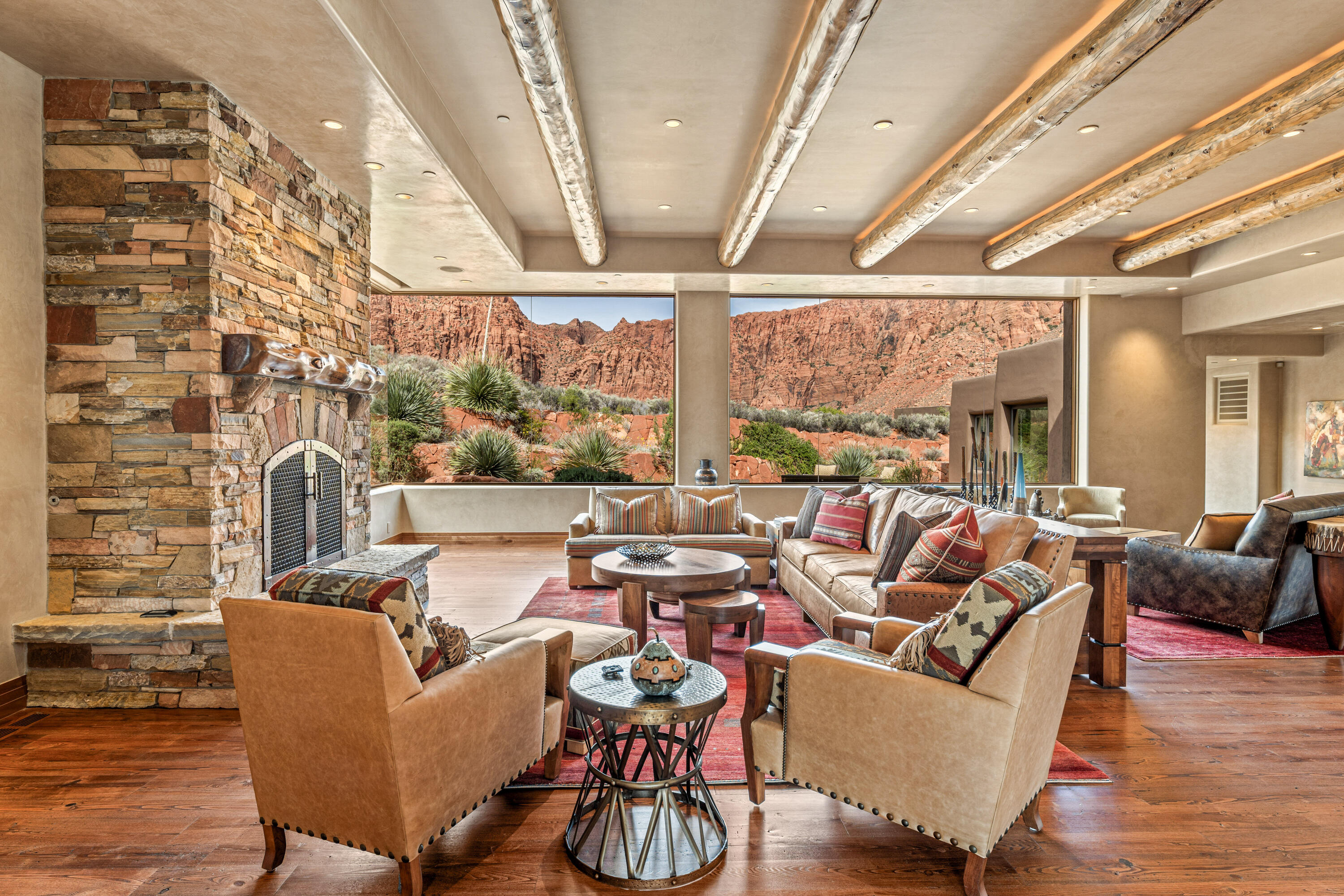 941 Sipala Trail is a rare luxury offering, one of those exceptional properties that seldom come to market.  Ideally positioned on a premium estate-sized lot in the prestigious Posovi Canyon enclave high above Kayenta (Southern Utah's premier desert community), this remarkable residence must be seen to fully appreciate all that it offers in terms of architectural presence, superior craftsmanship and meticulous attention to detail.  

The home is surrounded by lush, mature desert landscaping, with a dramatic, paver-lined driveway that creates a sense of arrival as it leads to the three-car garage.  The gracious and impressive front entry provides an air of privacy, tranquility and seclusion to those who enter.

Built on a 1.67 acre lot, a key highlight of this 6,812 square foot home is its grand-scale living spaces and meticulous craftsmanship, with its stunning hand-cut hardwood floor and wood-beamed ceiling, Venetian plaster walls and other high-end finishes, floor-to-ceiling stone fireplace, custom-made southwest contemporary design elements, and full length glass windows that dissolve the boundary between indoors and out, revealing breathtaking panoramic views of towering jagged red cliffs and thousand foot cascading seasonal waterfalls. 

 Adjacent to the living room and equally compelling is a spectacular formal dining area, capable of seating 12 or more and offering special views of the outdoor infinity swimming pool and sweeping views of desert sagebrush with the iconic Red Mountain trailing away in the distance.  The home is being listed inclusive of all furnishings, such as sofas, chairs, tables, bedroom suites, bedding and more...each piece custom made for a specific part of the house and creating a seamless, turnkey experience of understated luxury. 941 is ideal for entertaining friends and neighbors and is perfect for hosting extended family vacations and reunions.  The estate includes 5 bedrooms, 6 bathrooms, home theatre, executive office with built-ins, and a dedicated fitness space, located just off the primary bedroom.  
The gourmet kitchen, with its oversized kitchen island, is outfitted with high-end appliances (including 4 ovens), large walk-in pantry with integrated wine fridge, and charming breakfast nook with kiva fireplace and is a true culinary centerpiece.  It comes complete with small appliances, dishes, cutlery, and cookware, making the transition as smooth as possible for the new owners.  
The primary suite is an owners retreat, with tranquil sleeping area, panoramic views, kiva fireplace, barrel-vaulted ceiling, spa-inspired bathroom, expansive closet, and easy access to the office and fitness room.
The outdoor living space is equally impressive, with its fully-equipped kitchen (including refrigerator, gas cooktop, barbeque grill), covered patio space, infinity-edge pool and jacuzzi, and pool bathroom...again, the perfect oasis for entertaining family and friends while relaxing by the pool, soaking in the sun, and admiring the unsurpassed views in every direction.
The home is equipped with a sophisticated Lutron lighting system, home alarm with cameras, a generator, solar panels, whole-home audio system, theatre room projector, and so much more.  
Come experience the essence of luxury desert living...Kayenta style.  Come visit 941 Sipala Trail.