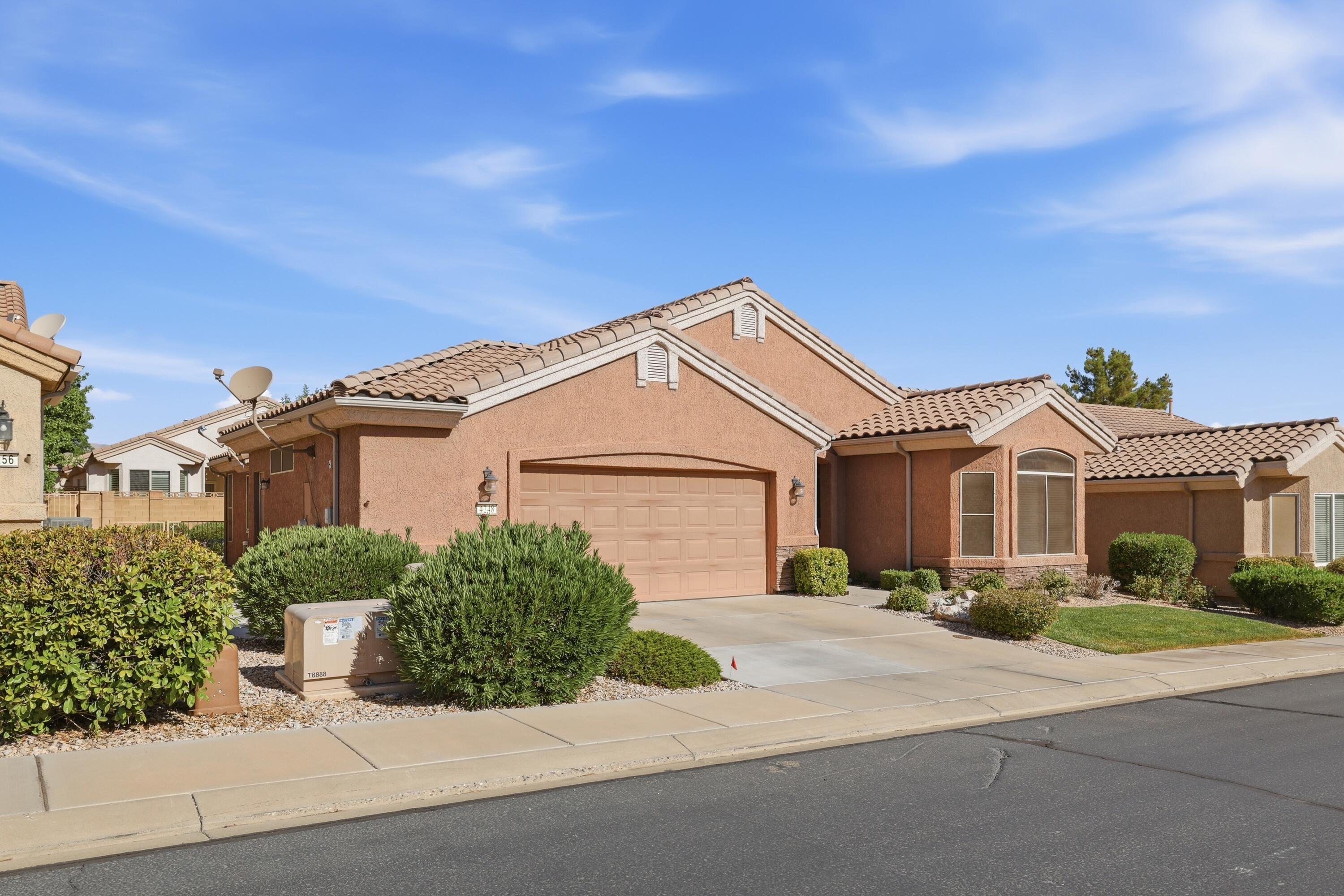 Welcome to the highly sought-after Cliffrose model in SunRiver St. George, where an active lifestyle and friendly neighbors create the perfect place to call home. Inside, you'll find no carpet--only upgraded tile flooring for easy cleaning, low maintenance, and lasting durability. The warm, inviting color palette creates a comfortable atmosphere you'll love coming home to. The upgraded kitchen is designed for both beauty and function, featuring granite countertops, stainless steel appliances, and a modified bay layout that provides additional prep space, extra cabinetry, more countertop area, and convenient pull-out drawers.
The spacious primary suite offers a private retreat, while the thoughtfully designed floor plan makes excellent use of every square foot with no wasted space and abundant storage throughout.
The oversized garage is another standout feature, complete with built-in overhead metal storage shelving to help keep everything organized.
This home blends comfort, convenience, and quality upgrades in one of Southern Utah's premier 55+ communities.