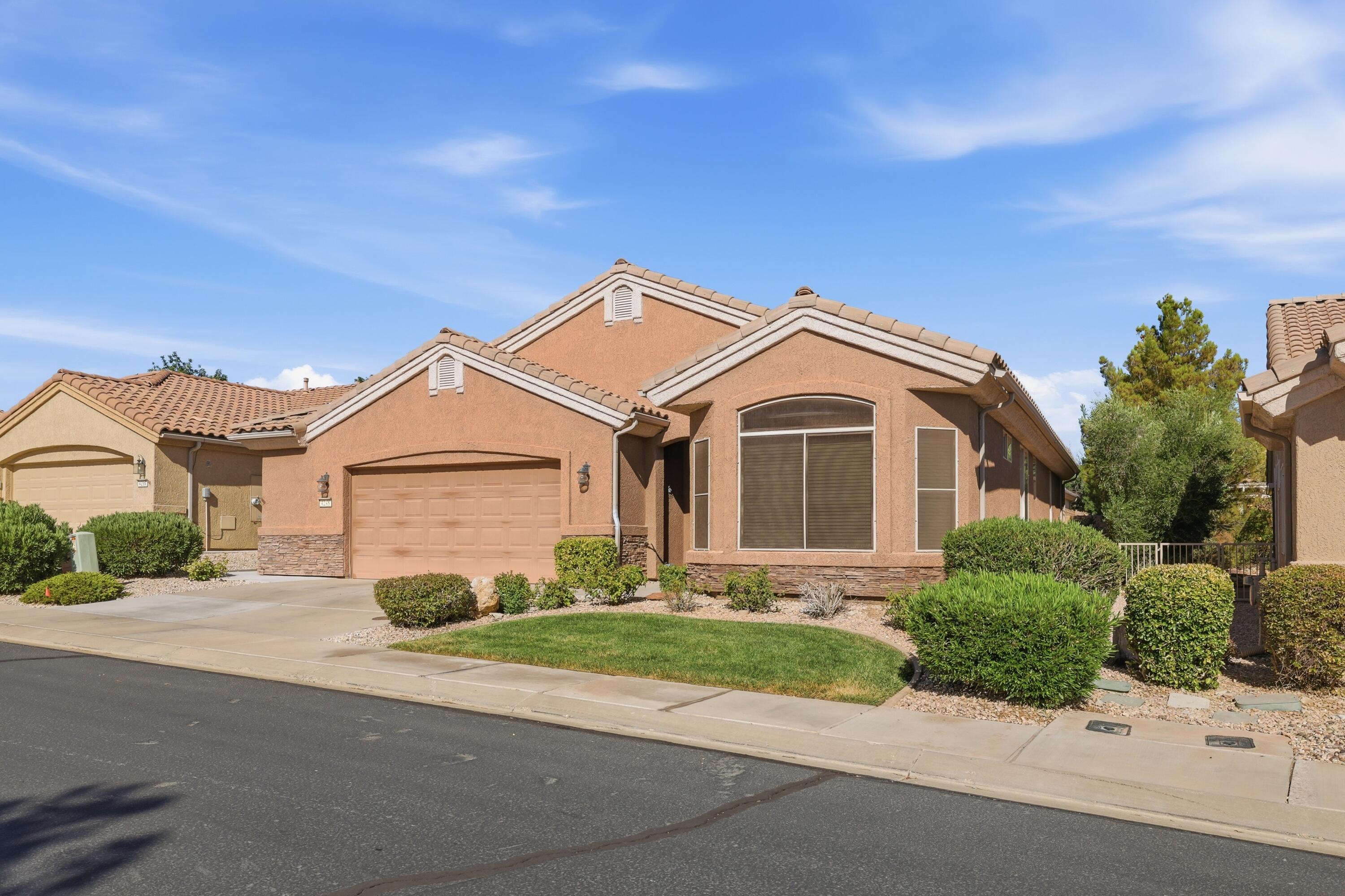Welcome to the highly sought-after Cliffrose model in SunRiver St. George, where an active lifestyle and friendly neighbors create the perfect place to call home. Inside, you'll find no carpet--only upgraded tile flooring for easy cleaning, low maintenance, and lasting durability. The warm, inviting color palette creates a comfortable atmosphere you'll love coming home to. The upgraded kitchen is designed for both beauty and function, featuring granite countertops, stainless steel appliances, and a modified bay layout that provides additional prep space, extra cabinetry, more countertop area, and convenient pull-out drawers.
The spacious primary suite offers a private retreat, while the thoughtfully designed floor plan makes excellent use of every square foot with no wasted space and abundant storage throughout.
The oversized garage is another standout feature, complete with built-in overhead metal storage shelving to help keep everything organized.
This home blends comfort, convenience, and quality upgrades in one of Southern Utah's premier 55+ communities.