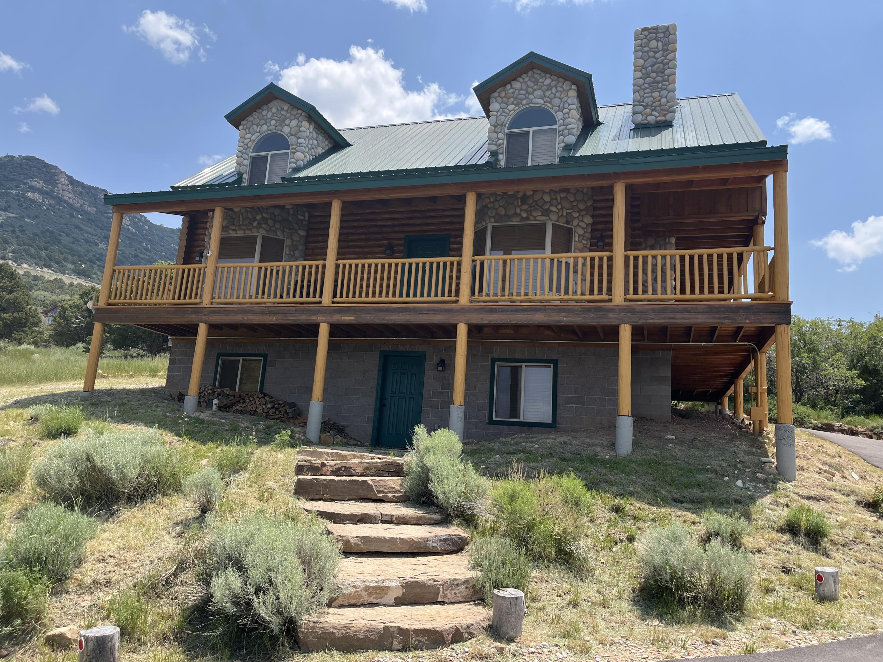 You really want to see this gorgeous cabin! OPEN HOUSE MONDAY< MAY 25th!! Fully Furnished, Gorgeous cabin in Cedar Highlands, immaculately kept with incredible views!! Turn-Key, minus personal items at this amazing price, ready to move in! New HVAC and water heater, fresh exterior paint/stain on wrap around deck and upstairs patio. Beautiful wood burning fireplace and two wood burning stoves for warmth and comfort. New garage with insulated door built on seven piers for lifetime stability with 100 AMP and 220 vac service with side door and window. Workshop, Snow blower, log splitter, leaf blower, and some tools included in the price.New asphalt driveway and parking. HOA includes snow removal and road maintenance. Enjoy the beauty and serenity of mountain living with breathtaking city views!