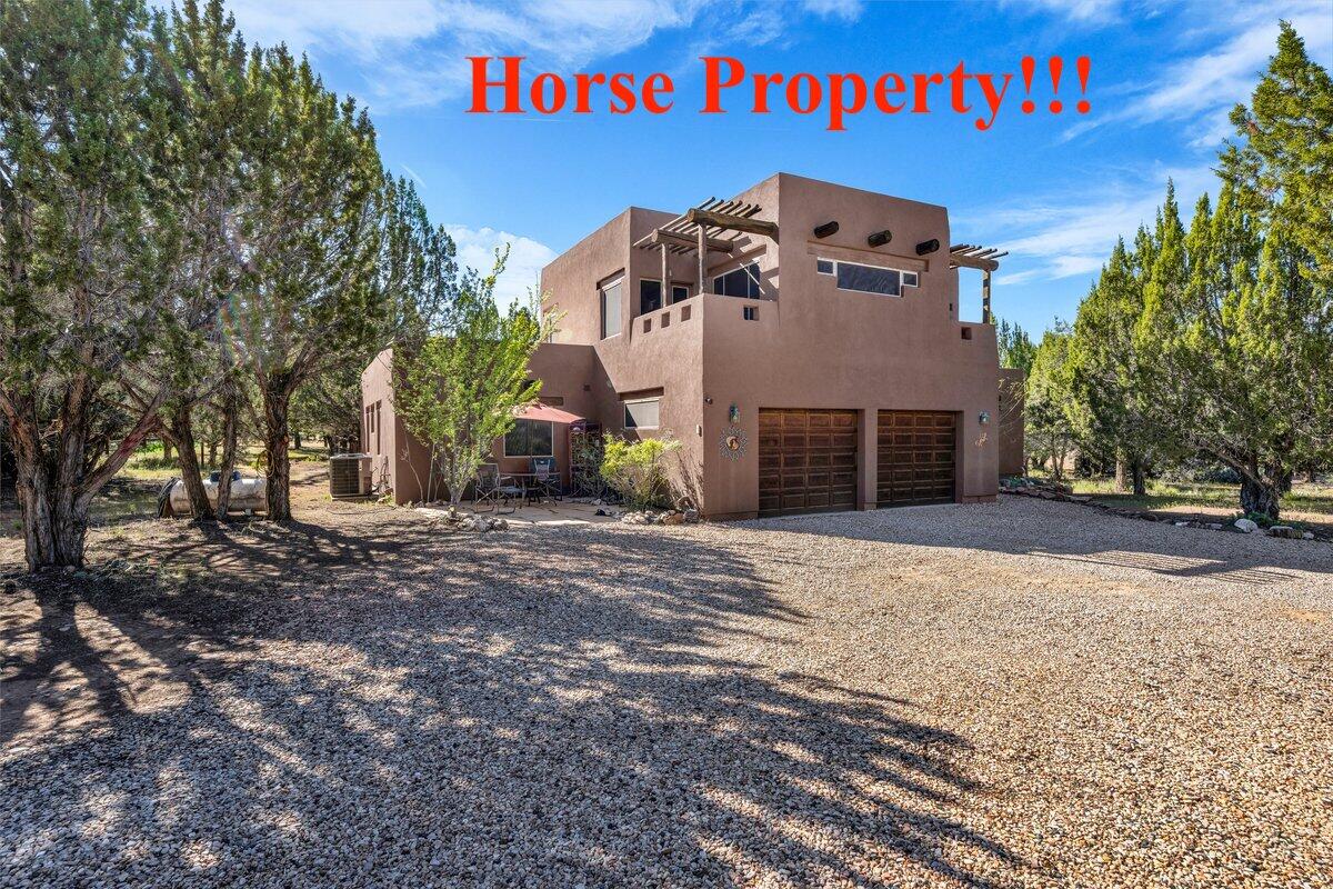 Custom remodeled home on .96 acre lot in the desirable Dammeron Valley community, offering a 480 sqft detached guest house with additional storage. From the moment you arrive at the circular driveway, this unique 2 story home makes a lasting impression with its warmth, character and thoughtful upgrades throughout. Inside, you'll find travertine tile, hardwood flooring, custom shutters, 3 fireplaces, wood beams, ceiling fans, brand new furnace and heat pump, updated stainless appliances, and 60 gal water heater just to name a few. The spacious kitchen is equipped with a gas cooktop, built in oven that opens to a large family room with a cozy fireplace. The main home features 3 bedrooms and 2.5 baths while the detached guest house includes 1 bedroom plus another storage room or optional bedroom. Upstairs, the primary suite features access to multiple private decks, along with an attached office/nursery/library. Enjoy scenic views from the upstairs landing. Additional highlights include hardwired smoke alarms, new stucco, drip system for plants, solar screens to keep out the sun. The backyard is perfect for relaxing under the wisteria or entertaining with a covered porch. A 2 car oversized garage, spacious laundry room with sink and front yard patio complete this exceptional property. Come experience the privacy, views and charm this home has to offer.