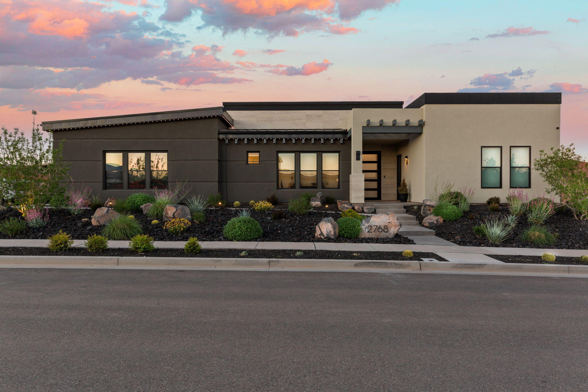 Experience elevated desert living in this stunning modern flat-roof home, perfectly positioned to capture breathtaking red rock views. Clean architectural lines and a thoughtfully designed layout create a seamless blend of luxury and comfort.

The main living area is anchored by a striking fireplace with a custom accent wall, adding warmth and visual impact to the open-concept space. Large windows invite in natural light while framing the surrounding landscape.

The kitchen and outdoor living spaces are designed for both everyday living and entertaining. Step outside to the true centerpiece of the home--a spectacular patio featuring panoramic views, a fire pit, and a built-in Wolf BBQ, creating an ideal setting for relaxing or hosting under the desert sky.

The primary suite offers a spa-like retreat with a separate soaking tub and a spacious walk-in shower complete with a built-in bench.

A private casita provides flexible living options, perfect for guests, extended family, or a home office.

With its modern design, high-end finishes, and unmatched views, this home delivers an exceptional Southern Utah lifestyle.
**Ask about the available furniture package as well