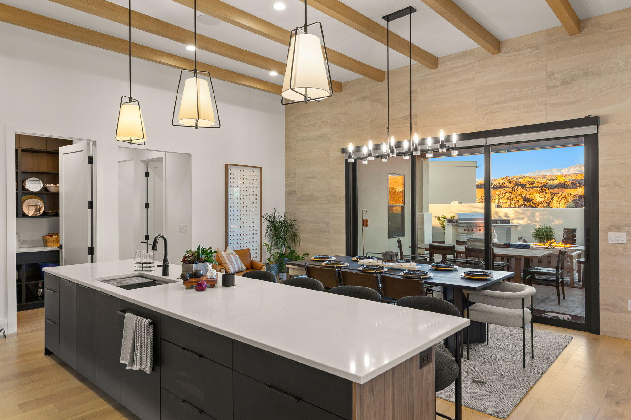 Experience elevated desert living in this stunning modern flat-roof home, perfectly positioned to capture breathtaking red rock views. Clean architectural lines and a thoughtfully designed layout create a seamless blend of luxury and comfort.

The main living area is anchored by a striking fireplace with a custom accent wall, adding warmth and visual impact to the open-concept space. Large windows invite in natural light while framing the surrounding landscape.

The kitchen and outdoor living spaces are designed for both everyday living and entertaining. Step outside to the true centerpiece of the home--a spectacular patio featuring panoramic views, a fire pit, and a built-in Wolf BBQ, creating an ideal setting for relaxing or hosting under the desert sky.

The primary suite offers a spa-like retreat with a separate soaking tub and a spacious walk-in shower complete with a built-in bench.

A private casita provides flexible living options, perfect for guests, extended family, or a home office.

With its modern design, high-end finishes, and unmatched views, this home delivers an exceptional Southern Utah lifestyle.
**Ask about the available furniture package as well