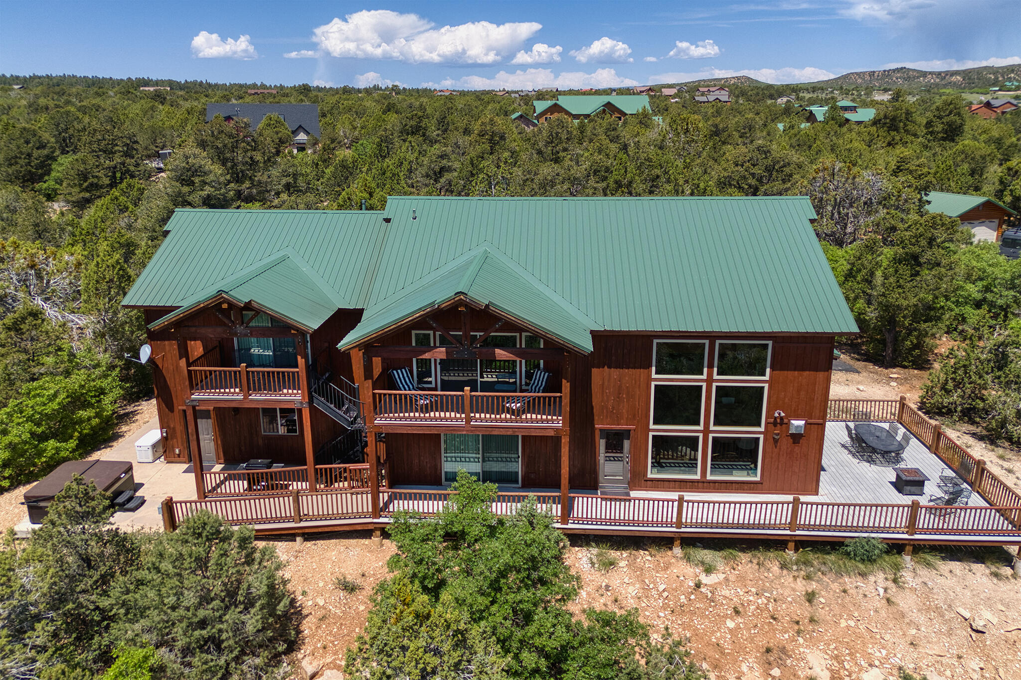 Approved nightly rental in East Zion, now even better with a full suite of upgrades. This fully furnished, turnkey mountain home sits on 1.26 acres at the end of a quiet cul-de-sac in the gated Zion Ridge community. With 4,003 square feet, five bedrooms, and five bathrooms, including two spacious master suites. There is plenty of room for family, guests, or rental groups. The home has been thoughtfully updated to create an even more comfortable and enjoyable experience. A brand-new hot tub now sits on the back patio, paired with new outdoor furniture for relaxing evenings under the stars. Inside, you'll find all-new smart TVs throughout, fresh linens and towels, and a beautiful new dining table perfect for gathering. Newly installed fiber optic internet is lightning fast. The garage has been fully converted into a dedicated game room with a complete arcade setup and new epoxy floors. 

The home features open-concept living with a large kitchen, stainless steel appliances, granite throughout, and an oversized fridge and freezer. Both primary suites open to private decks with sweeping views, and a second upstairs living area provides extra space for entertaining or larger groups. Additional value includes a new HVAC system, lifetime warranty windows, and a whole-home backup generator. 

Just 8.5 miles to Zion's East Entrance, this is an ideal basecamp for adventure or a peaceful retreat. Close to Zion Ponderosa Ranch, the Applecross mountain bike trails about a mile down the road, and easy access to Kanab, Lake Powell, and the North Rim of the Grand Canyon.

Whether you're looking for a personal getaway or a strong investment property, this East Zion nightly rental is ready to impress.