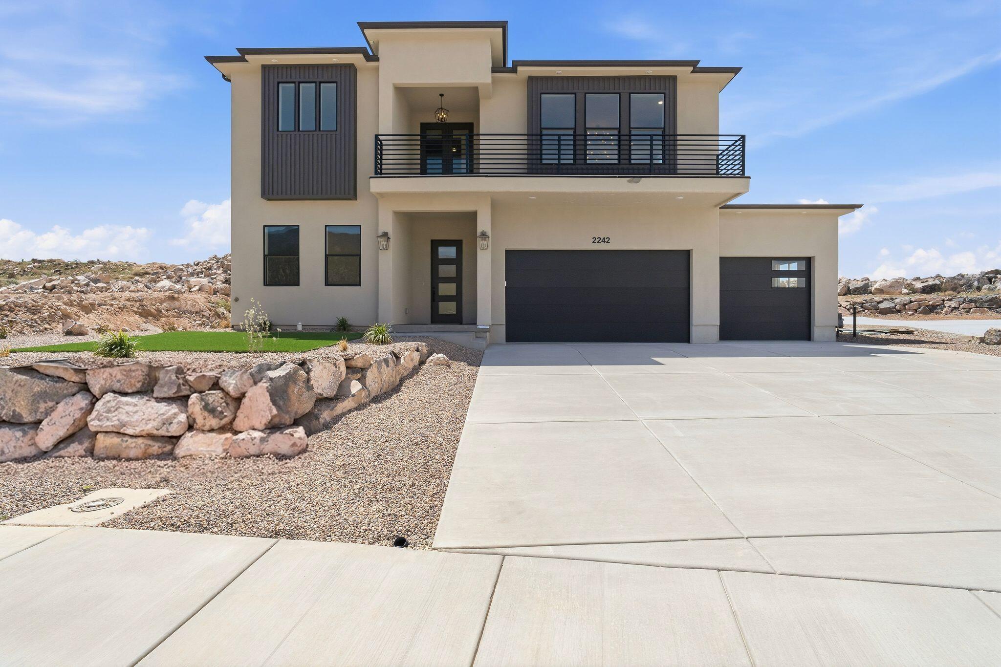 Experience luxury and modern living in this stunning, modern two-story home located in the beautiful Talon Pointe at South Mountain development. Oasis is not just a home; it's a sanctuary where comfort meets modern elegance, surrounded by breathtaking mountain views. 3 car garage fully finished with workshop area, 4 Beds, 3 Baths, and main level office that can be converted to a 5th bedroom. 10' ceilings on main, 9' ceilings on 2nd floor. Luxurious primary suite/ensuite features private covered patio, walk-in closet, tile flooring with oversized rain shower, soaking tub, dual vanity, makeup desk and all granite or quartz surfaces. Large Laundry Room, custom cabinetry and sewing/crafting desk. Gourmet Kitchen equipped with stainless 36'' gas range, refrigerator, disposal and dishwasher. Large Windows provide natural light and contribute to a spacious open feeling. Oversized Island. Granite Surfaces and tile backsplash. Walk-In Butler Pantry. Adjoining Dining Area and Great Room is ideal for entertaining and family gatherings or just relaxing. The fully landscaped yard includes a sprinkler/drip system, artificial turf, desert friendly plants and xeriscaping for low-maintenance. Two units and zoned HVAC systems keeps Oasis comfortable year-round. 240v/50 amp outlet in garage provides access for EV charging, RV plug-in or specialty tools. Solar-Ready Electrical Panel. See virtual tour for more! Square footage figures are provided as a courtesy estimate only and were obtained from architectural plans. Buyer is advised to obtain an independent measurements and verify property taxes with Iron County.