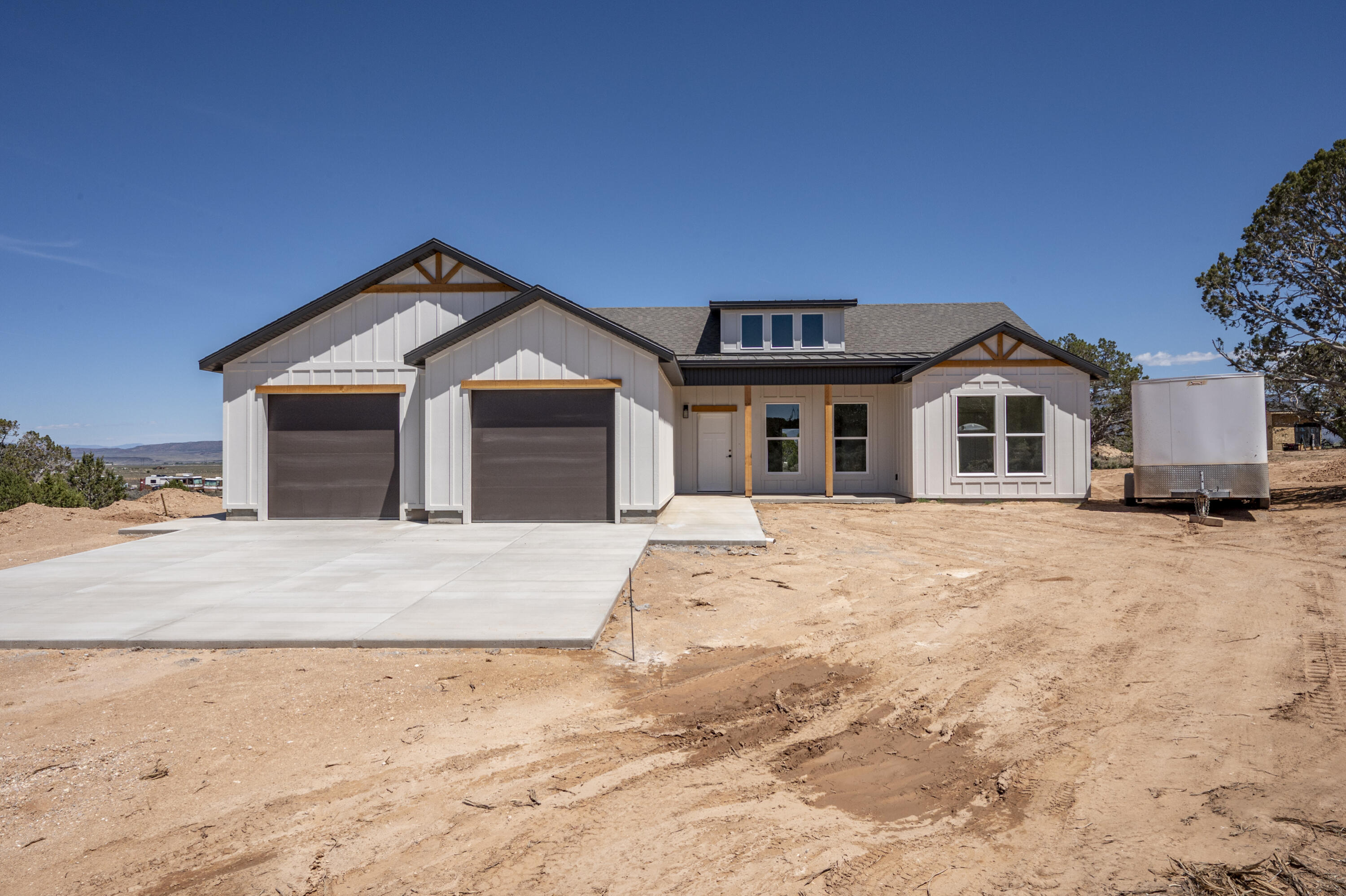 Enjoy country living in this beautiful new construction home situated on 1.25 acres in a peaceful rural setting with animal rights and plenty of room to spread out. This 3-bedroom, 2-bath open concept home offers quality finishes throughout, including custom cabinets, granite countertops, durable LVP flooring, and beautiful custom details. The spacious primary suite features a stunning tile shower with double sinks, double shower heads, and a relaxing soaker tub. You will love the rough sawn exterior details, board and batten Hardie siding, large covered patio and stucco exterior. Bring your RV, trailers, toys and animals-there is ample parking and space to create your own mini farm or hobby property! Comes with .5 acft of water on a shared well. Property is under contract with a time clause Addendum.