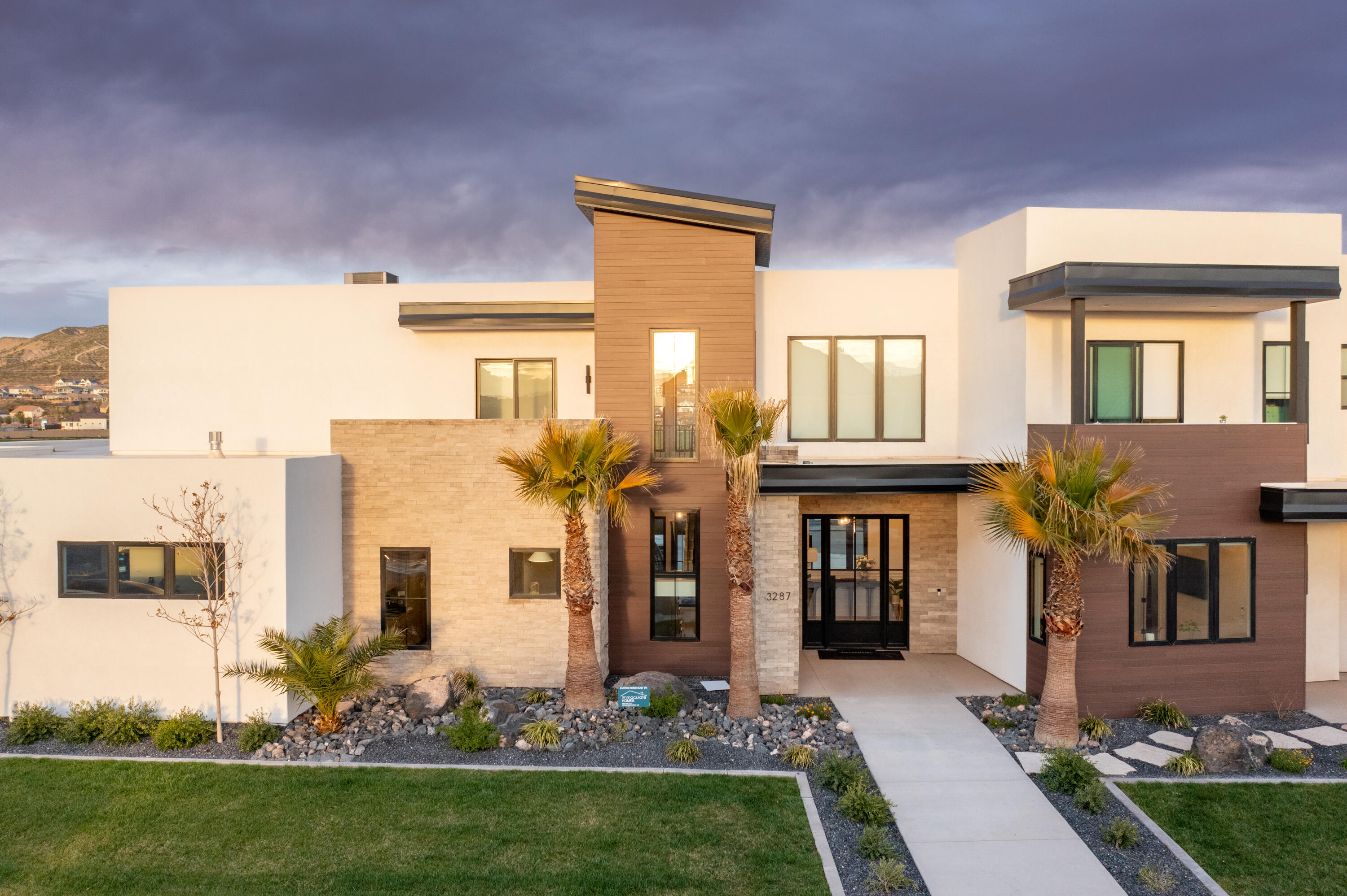 Modern design meets elevated desert living in this stunning 5-bedroom luxury home in St. George, thoughtfully crafted for entertaining and unforgettable gatherings. Clean architectural lines, expansive windows, and striking contemporary finishes create a home that feels both sophisticated and welcoming.
The open-concept layout flows effortlessly, allowing indoor and outdoor living to blend seamlessly. Multiple balconies capture breathtaking mountain views, creating the perfect setting for sunrise coffee or unforgettable sunset gatherings.
Designed with hosting in mind, the spacious living areas and sleek modern kitchen provide an ideal backdrop for everything from intimate dinners to lively celebrations.
Beyond the five beautifully appointed bedrooms, this home offers a truly unique wellness retreat. Tucked discreetly within the home, a hidden yoga room creates a private sanctuary complete with a steam shower and sauna, offering a spa-like experience designed for relaxation, recovery, and balance.
A private casita provides incredible flexibility for guests, extended family, or a separate retreat space allowing visitors to enjoy privacy while still being part of the home.
Bold architecture. Thoughtful design. Captivating mountain views.
Be Bold. Live Beautifully. Welcome Home.
