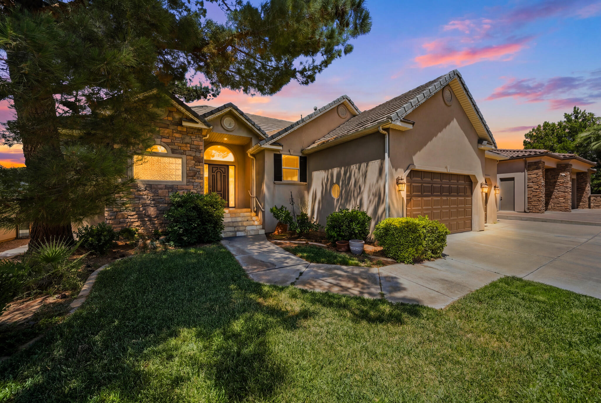 Welcome to 1727 E Flagstone Drive, a beautifully updated home in the highly sought-after Boulders neighborhood--one of St. George's most established and desirable communities.

After temporarily being taken off the market, the sellers made a significant investment into the property, enhancing the landscaping, refreshing key areas throughout the home, and ensuring it is truly move-in ready for its next owner. The result is a home that feels fresh, polished, and ready to enjoy from day one.

Offering 6 bedrooms, 4 bathrooms, and an exceptional amount of living space, this home blends timeless craftsmanship with modern comfort. Rich wood flooring, alder cabinetry, granite countertops, and a spacious island kitchen create a warm and inviting atmosphere, while the open-concept great room with fireplace provides the perfect gathering place for family and friends.

The expansive primary suite offers a private retreat with dual closets and a spacious ensuite bath designed for comfort and functionality. Downstairs, the fully finished basement provides incredible flexibility with additional living, entertaining, fitness, game room, or guest space options.

Step outside and enjoy a fully fenced backyard with mature landscaping, lush grass, and beautiful views of Southern Utah's iconic red rock surroundings. Whether you're hosting friends, watching the kids play, or simply enjoying a quiet evening outdoors, the backyard is designed to be enjoyed year-round.

Location is where this home truly shines. Residents love being just minutes from the shopping, restaurants, grocery stores, and everyday conveniences found along River Road and at River Crossing. Nearby fitness facilities, parks, walking paths, and outdoor recreation make it easy to stay active, while quick access to major roads allows you to reach virtually anywhere in St. George within minutes. Homes in The Boulders rarely offer this combination of size, location, updates, and move-in readiness. This is an opportunity to enjoy an established neighborhood, mature landscaping, spacious living areas, and one of the most convenient locations in all of St. George.

Come experience why so many people love calling The Boulders home.