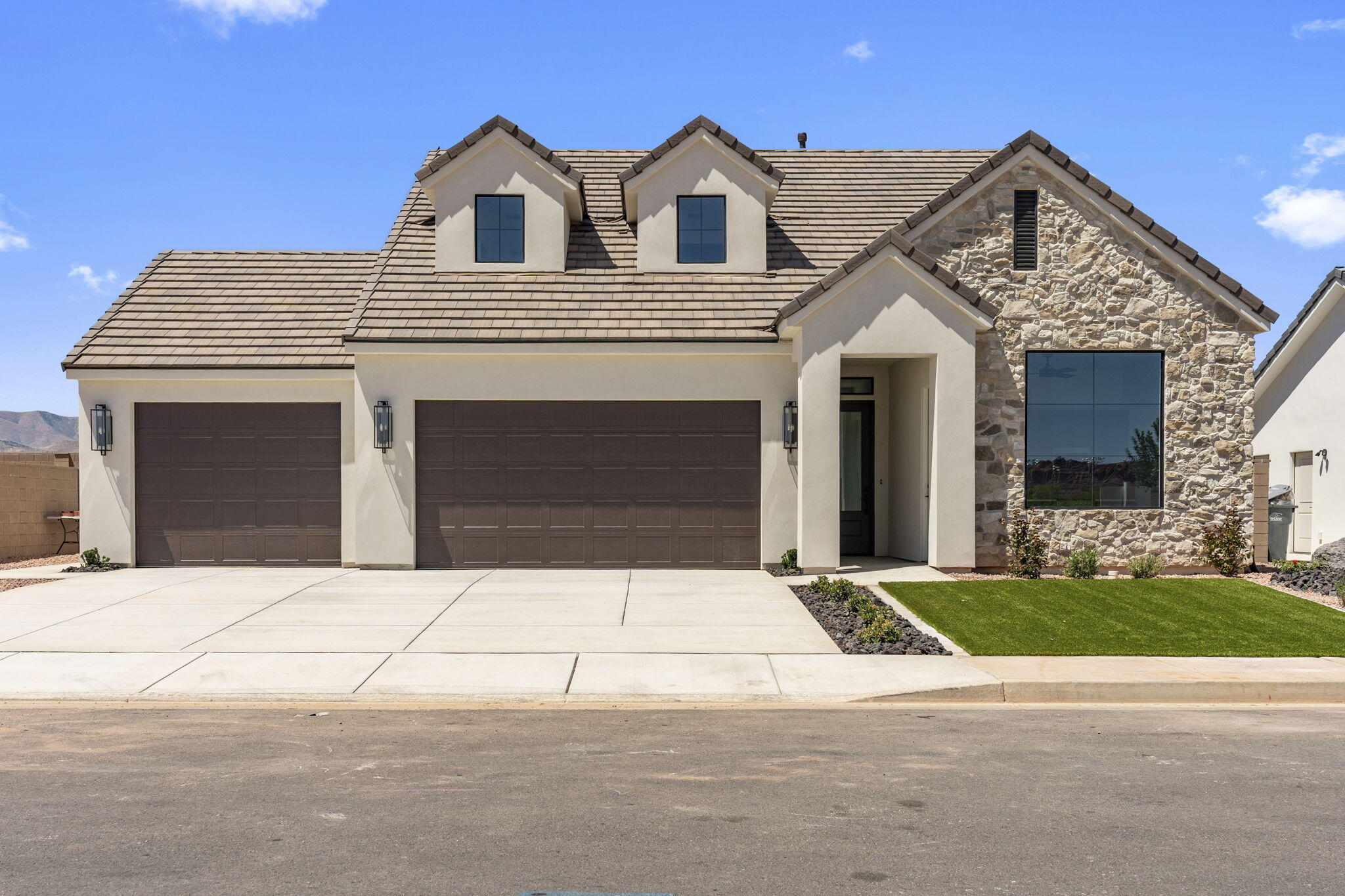 Introducing the Sunflower floor plan in beautiful Santa Clara, UT -- a thoughtfully designed 4-bedroom, 4-bath home offering 2,274 sq ft and an oversized 3-car garage. This upgraded home includes a legal IADU, providing excellent income potential to help offset ownership costs. Enjoy mountain views from the front deck and flexible living space with an upper loft. Designer finishes are included with transparent pricing--no surprise upgrades. Features include completed landscaping with side and rear block wall, upgraded stone and smooth stucco exterior, black-framed windows, gourmet kitchen with upgraded appliances, 42'' upper cabinets, tile surrounds, upgraded flooring, custom closet shelving, and a concrete rear patio. Located near Black Desert Resort, Harmons, and Gubler Park. kitchen package with upgraded appliances and microwave, tile shower and tub surrounds, upgraded carpet and hardwood flooring, custom closet shelving, walk-in closets, and extra garage storage space. Fully finished landscaping and backyard improvements are already completed.
Located in a desirable Southern Utah community near Black Desert Resort, Harmon's Grocery, Gubler Park, and numerous recreational amenities. Ask about community features and additional availability. This home blends quality craftsmanship, thoughtful design, income flexibility, and prime location a rare opportunity in Santa Clara.