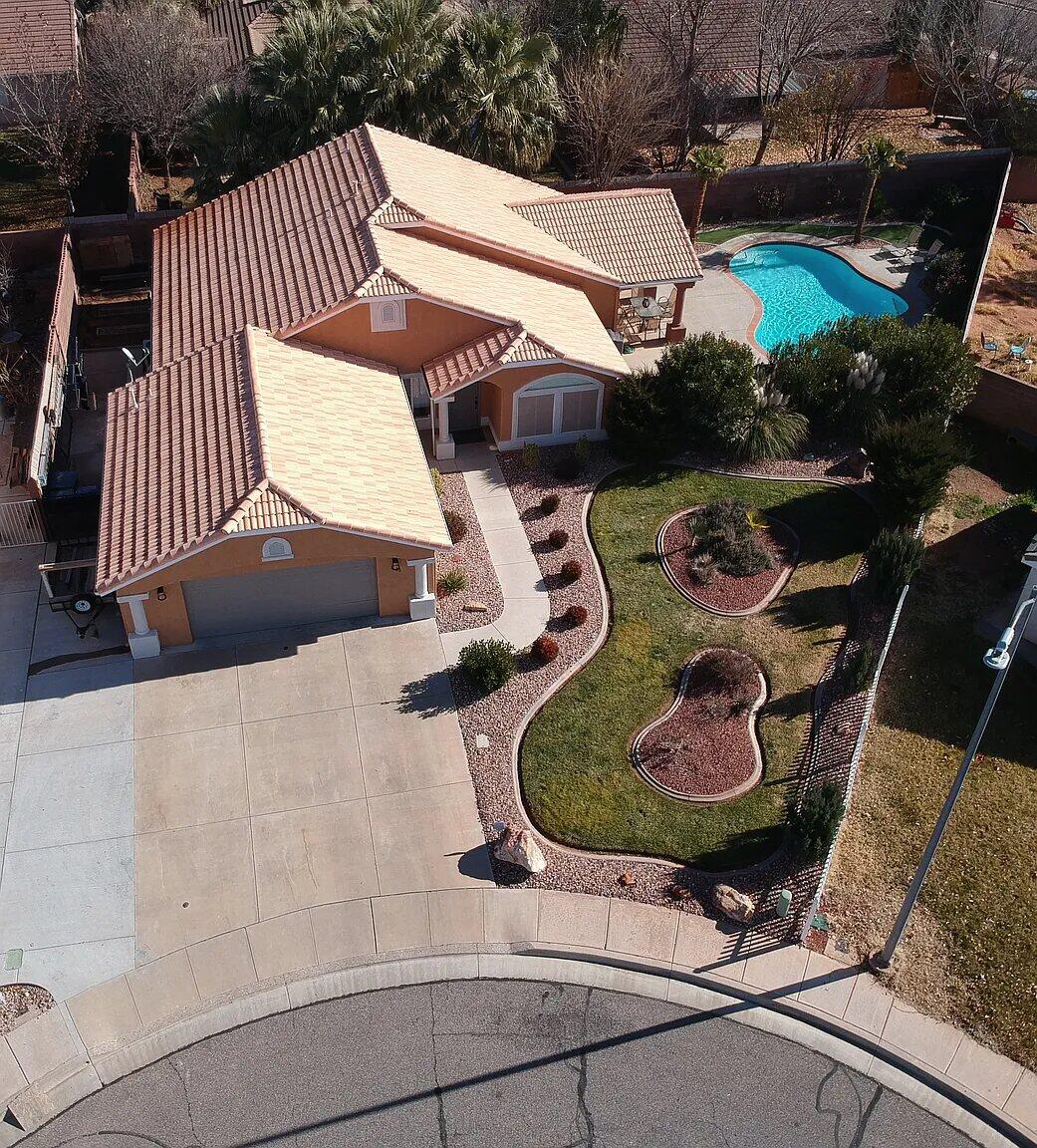HIDDEN GEM with great location tucked away in cul-de-sac with NO HOAs and PRIVATE HEATED POOL! Open and spacious floor plan with 3 bedrooms and 2 bathrooms. Primary suite with walk in his/her closet with built in drawers and shelves, walk in shower and double sinks in spacious bathroom. Two additional bedrooms with vaulted ceiling and closet built ins. 

Beautiful entry bonus room with Wood Laminate Flooring and New French doors Overlooking your Private Pool, this Room will make a Great
Office/Den, Media Room or Exercise Room. Upgrades include Vaulted Ceilings with Wood Beams, Plantation Shutters, Granite Countertops
in Kitchen and Bathrooms, Quiet-Close Cabinets, Large Storage/Pantry Room off Garage, Small Work Area and Above Storage in Garage,
just to name a few. RESORT STYLE OASIS Backyard with recently (2021) Resurfaced and Heated Gunite In-Ground Pool, Outdoor Kitchen, Putting Green, Outdoor Shower, New Pergola (2024), Reading Nook, and Mature/Low Maintenance Landscaping...all enclosed with an 8 Ft. cinderblock privacy wall. Side Gate and Concrete Walkway leads behind the house to more space on the other side of the house with garden/workout, play area etc...possibilities New Water Heater 2024, Water Softener(2024), Bathroom Fixtures(2024) Amazing location within minutes to Shopping, Cinema, and Hiking Trails in the Red Rocks. Park and Walking/biking path around the corner that connects you to all of the St. George area. Short bike ride to Tuachan, Snow Canyon, and the new Black Desert Resort. Quiet neighborhood with fantastic neighbors. Home Warranty offered with reasonable offer.