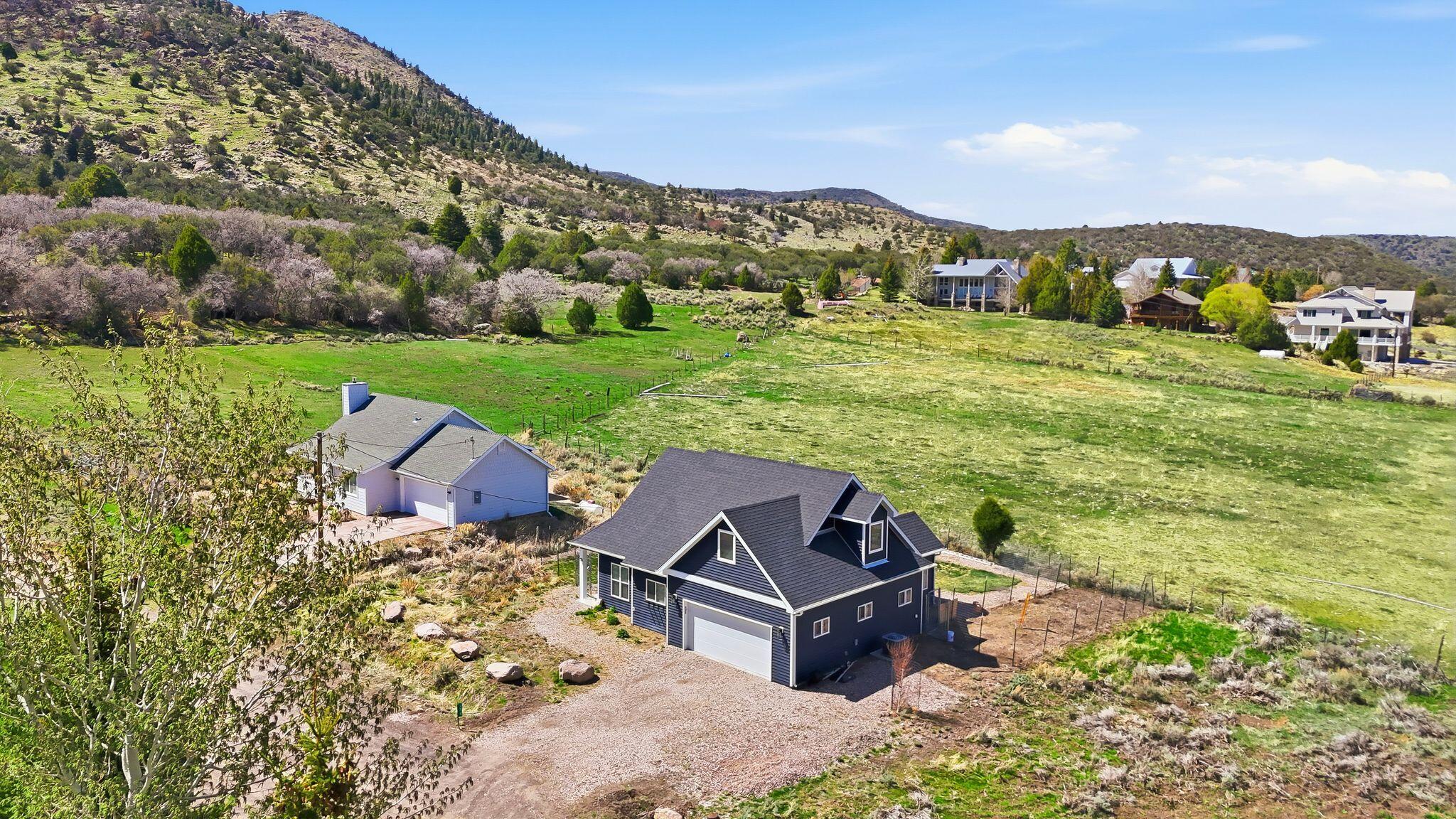 Make this beautiful, five-year-old custom designed and built home your Pine Valley getaway or fulltime residence. A main floor principal bedroom, bath, and laundry provide convenience. You'll love the multi-purpose bunk room for sleeping kids, gardening, hobbies, and extra storage.  Enjoy the comfort and convenience of amenities such as a large soaking tub/shower combo, 2 water heaters, an oversized 2-car garage, lots of exterior parking and a fully finished bonus space. Details include custom cabinetry and built-ins, quartz countertops, tile backsplash, LVP and 9' ceilings throughout the main floor. The induction range, 2 refrigerators and washer/dryer are included.You'll appreciate the energy efficient electric heat pump on Dixie Power keeping utility bills in check. The low maintenance wildflower garden attracts birds and butterflies while minimizing outside chores. This fun weekend or everyday retreat is surrounded by open space on a quiet dead-end street with gorgeous Pine Valley views.