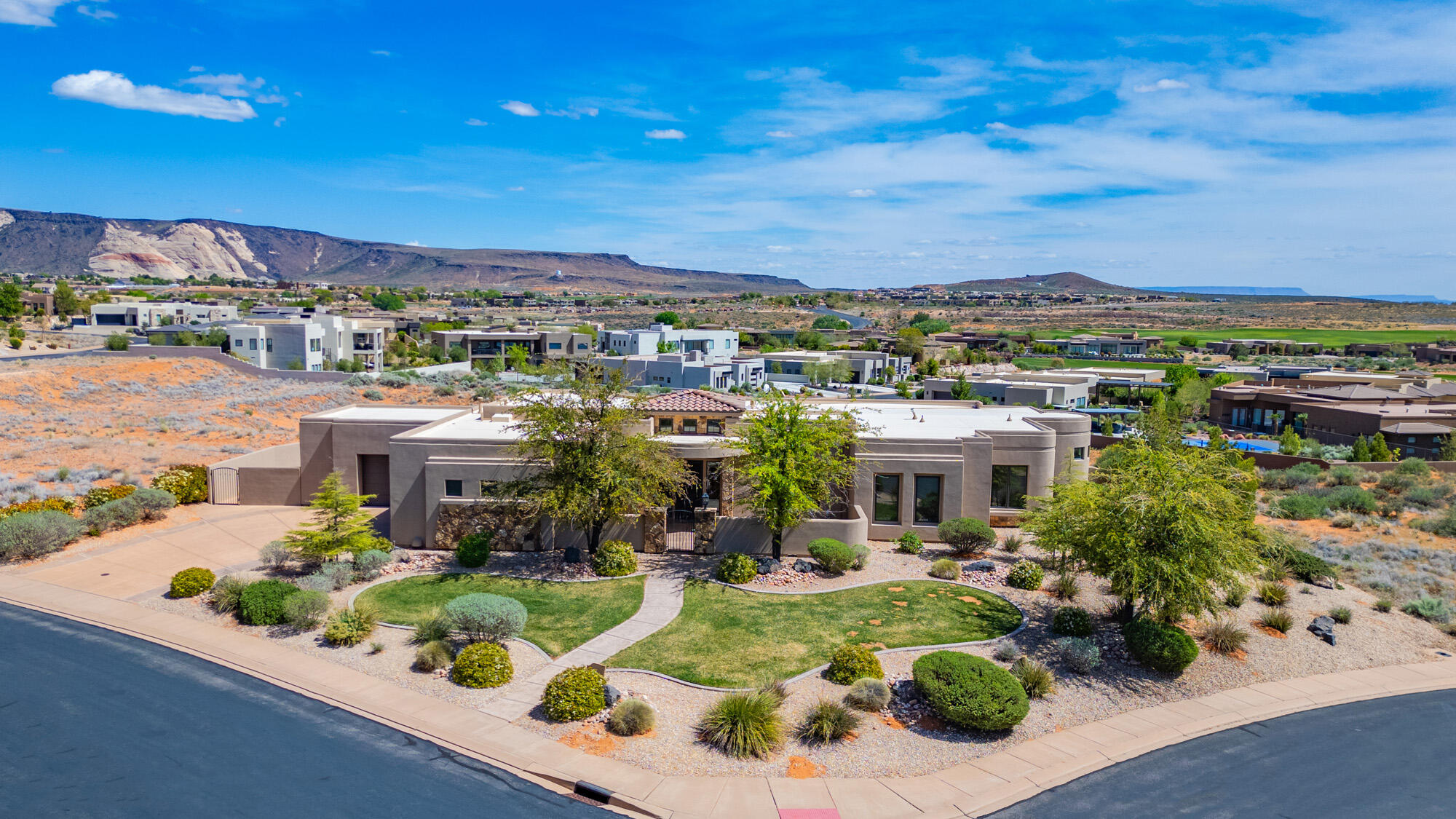 Exceptional luxury estate located in the prestigious gated community of The Ledges, offering breathtaking 360-degree red rock and mountain views. Perfectly positioned on a premier corner lot, this remarkable home features an inviting front courtyard, patios, and expansive decks designed to maximize indoor-outdoor living and showcase the spectacular Southern Utah surroundings.

The open-concept floor plan is filled with natural light and offers spacious living areas ideal for both entertaining and everyday comfort. The expansive main-level primary suite serves as a private retreat and includes a cozy sitting room, perfect for relaxing and enjoying the views.

The beautifully landscaped backyard creates a private park-like setting with no visible neighbors and features a private pool, providing the ultimate in privacy, tranquility, and outdoor enjoyment.

The walk-out basement offers exceptional flexibility for multi-generational living, a guest suite, or private living quarters, complete with a large family room, partial kitchen, spacious bedroom, full bathroom, abundant storage, and direct outdoor access.

A rare opportunity to own a truly one-of-a-kind luxury home with private pool, panoramic views, and separate living space in one of St. George's most sought-after communities.