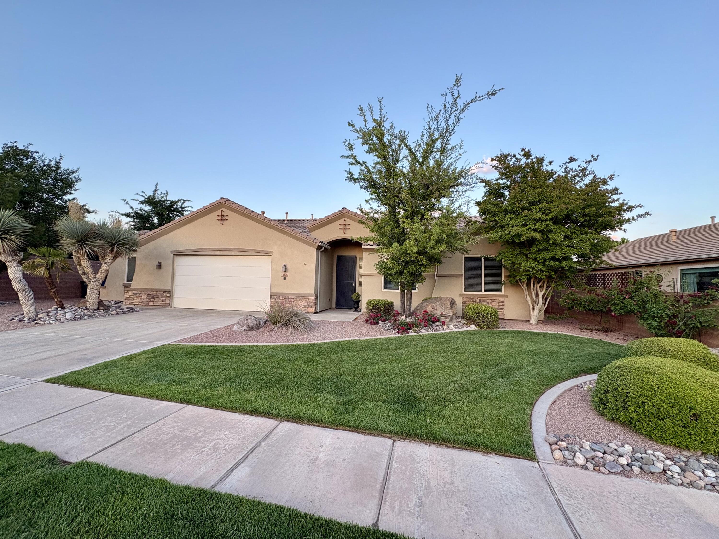 This home is located in a peaceful neighborhood, only minutes away from multiple supermarkets, restaurants and 10 minutes from downtown St George. This home features fresh paint throughout, including cabinets. Updated hardware, and light fixtures, a refreshed fireplace, pet-proof LVP in the bedrooms and living area and new appliances. With an already large feeling 2 car garage thanks to shelving, draws, cabinets and wash basin, this boasts an attached workshop area, perfect for storage or all your home projects. Take advantage of the easy care desert landscaped back yard and planter boxes ready and waiting for your inner green  thumb to emerge. 

Primary closet has been rebuilt to maximize storage space, and once you've filled that up, unwind in the jetted tub. The third room can be used as an office or bedroom with it's window, closet and roll up blinds on the doors.