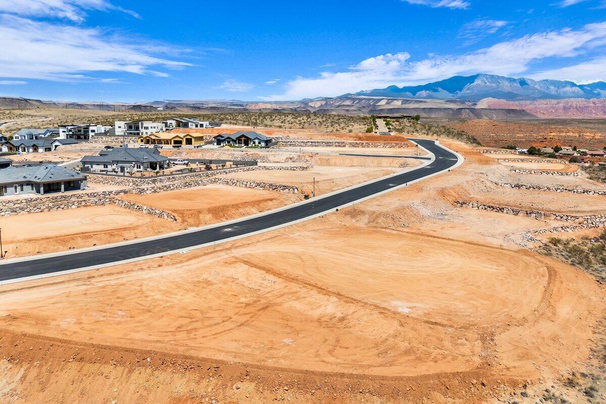 Premier rim view lot with exceptional views overlooking the city, mountains, Pine Valley, red rock mesas, Sand Hollow, and even Zion National Park! Best suited for a rambler floor plan, this lot is located in the final phase of Grand Heights, the highest elevated subdivision in St. George proper, nearly 500 feet higher than the rest of town, including Stone Cliff and Foremaster, offering unmatched views. Enjoy quick access to downtown, hiking and biking trails, and off-road adventures, plus you're just 15 minutes from two major fishing reservoirs and over half a dozen top-rated golf courses. With BLM land bordering the subdivision, you can ride bikes and ATVs straight from your doorstep. Numerous oversized lots are available with convenient highway access. Bring your own builder! Buyer is responsible for water impact fees. All construction requires prior review and approval by the architectural control committee. Buyer to verify all information, deemed reliable, however buyer to verify all info including utilities & ACC information if applicable.