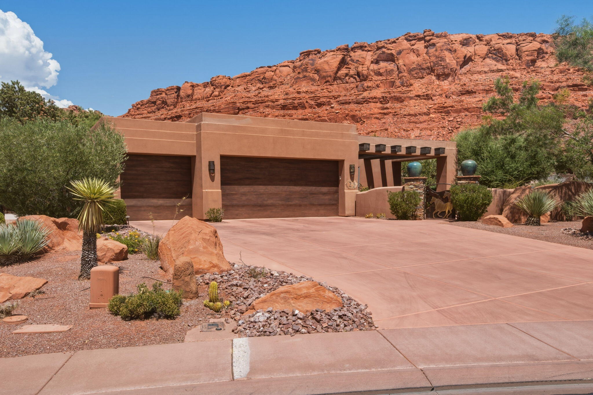 Nestled in the gated community of Kachina Springs, this 3-bedroom, 3-bathroom home is perfectly positioned to enjoy shaded afternoons and evenings, making the backyard and patio comfortable year-round. Since 2025, the home has been thoughtfully refreshed with a beautifully updated living room, an enhanced kiva-style fireplace that serves as a stunning focal point, and refinished trim on the coffered ceilings. A private courtyard entry with striking wood beam accents welcomes you inside, where stamped concrete floors, plantation shutters, and dramatic floor-to-ceiling butted glass windows create a light-filled, elegant atmosphere. The spacious primary suite features a gas fireplace, private patio access, a soaking tub, walk-in shower, and separate closets. The kitchen offers granite countertops, skylights, and premium Sub-Zero, Wolf, and Fisher & Paykel appliances, flowing seamlessly into the inviting great room. Step outside to your private backyard complete with a built-in misting system, waterfall, and breathtaking red rock views. Additional highlights include a 3-car garage with a mini-split HVAC system and a wet/dry central vacuum.