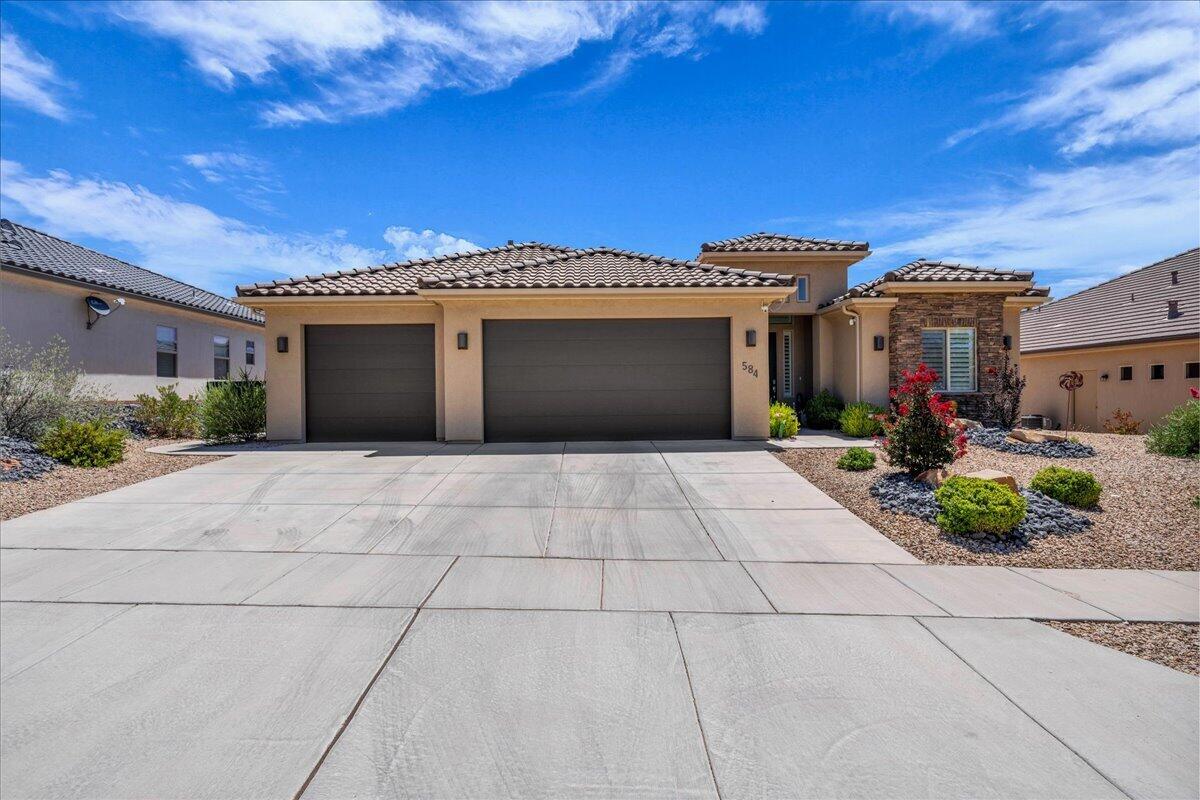 The curb appeal and beautiful landscaping is just the teaser to get you into this lovely home.  Once inside, the open floor plans shows you the updates and upgrades that make this home move in ready.  True pride of ownership here.  Tastefully decorated w/ stunning engineered hardwood floors, custom gas fireplace, plantation shutters and a kitchen made for entertaining.  Primary bedroom w/ ensuite bath that has been redesigned and remodeled with new cabinets, quartzite counters and a custom walk in closet.  Third bedroom is currently used as an office (no closet but one could be added).  Ready for a bit of outside time?  Take it to the covered back patio and enjoy a game of putt golf on your own personal putting green.  Extra perk with newly installed Gemstone exterior lighting.  So much to offer with this home that is located in one of Washington Counties most desired locations.  Walking and biking paths in neighborhood.  A short drive to Sand Hollow Reservoir, Quail Creek and all the perks of Southern Utah.  Sq. footage from county records.