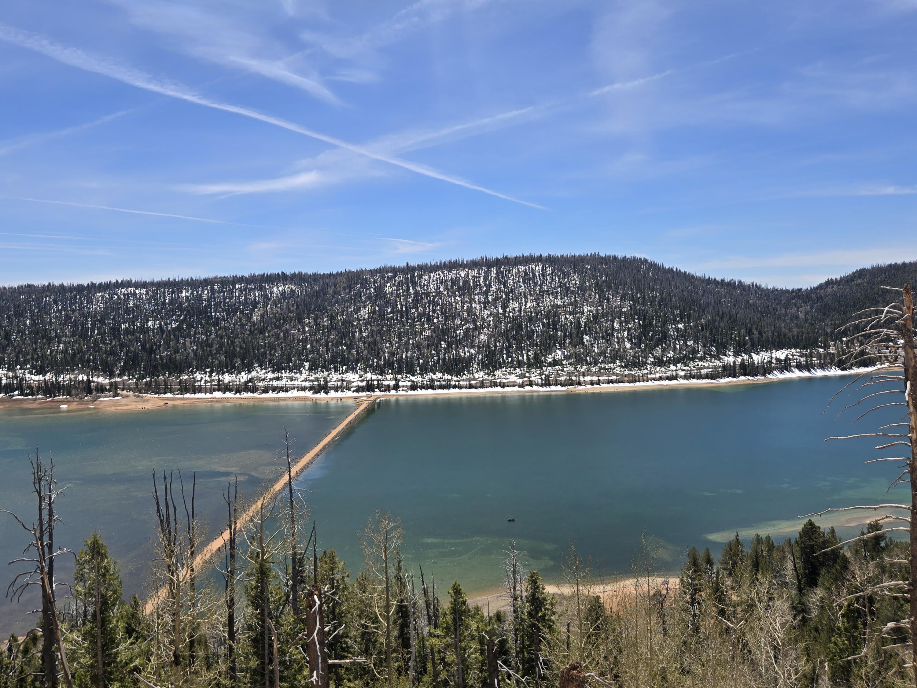 5465 W Berry Loop, Lot 56, Navajo Lake Estates - Duck Creek Village, UT
This serene 0.50-acre wooded lot offers a private mountain retreat in Navajo Lake Estates near Duck Creek Village. Mature trees line the road, creating a peaceful, scenic setting at high elevation on the Markagunt Plateau in Dixie National Forest.
Just minutes from Navajo Lake (approx. 9,200 ft), enjoy excellent fishing for rainbow and brook trout, boating, kayaking, swimming, and cool summer breezes -- a refreshing escape from the desert heat. The surrounding forest provides outstanding recreation: hiking the Navajo Lake Loop Trail and Virgin River Rim Trail, ATV riding on the Markagunt OHV system, mountain biking, wildlife viewing, and photography. Easy day trips to Cedar Breaks National Monument, Bryce Canyon, and Zion National Park.
Ideal for off-grid or seasonal use. Water is hauled from a natural spring only about 2 miles away for convenient tank refills. Power via solar or generator. The lot has already been excavated and graveled with over $10,000 in site improvements, making it ready for immediate RV use, glamping, or future cabin construction.
Duck Creek Village, at approximately 8,400 ft elevation, is a small mountain community offering shops, restaurants, lodges, and access to year-round adventures in Southern Utah's high country. Road access in Navajo Lake Estates is typically seasonal (generally April-November), aligning with prime summer and early fall enjoyment.
Whether you seek a weekend basecamp, RV getaway, or cabin site, this parcel delivers location, recreation, and tranquility.