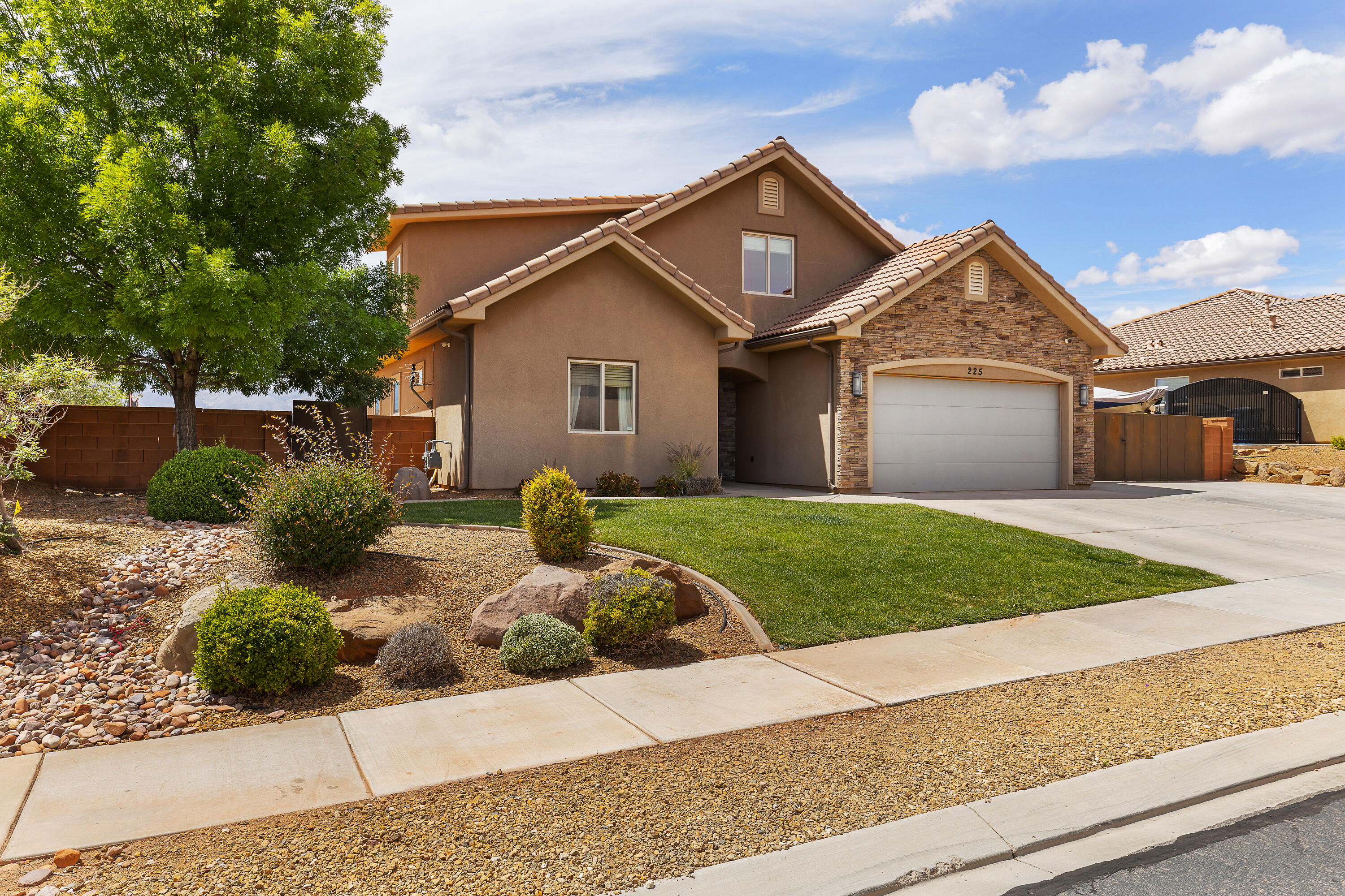 Located at the base of Red Mountain in desirable Ivins UT, this stunning 2,456 sq ft home offers 4 bed, 3 bath, spacious 0.23-acre lot in a quiet neighborhood. Built in 2012, rock/stucco exterior, tile roof, and beautifully landscaped. Enjoy breathtaking red mountain views from the oversized backyard with block wall fencing, in-ground trampoline, gas fire pit hookup, and room for a pool/outdoor kitchen. Inside offers upgraded tile, brand new carpet, can lighting, gas range, bar seating, and abundant storage throughout. Functional layout with main-level primary suite, plus two living spaces including an upstairs family room and bonus study area. RV parking and 2-car garage. HOA $100/month includes front landscaping. Minutes to Black Desert Resort and near Snow Canyon for hiking/biking.
