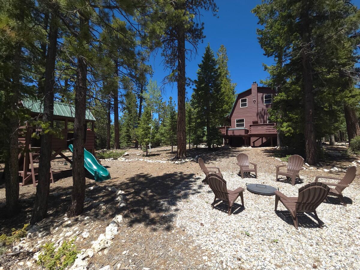 Experience the ultimate mountain retreat with this beautifully 2 bed 1.5 bath cabin offering over 1,600 sq ft of comfort on three scenic lots backing the Dixie National Forest. Surrounded by trees and abundant wildlife, this turnkey getaway blends rustic charm with modern convenience. The open-concept living area features expansive windows, stunning forest views, and a cozy wood-burning stove that creates the perfect mountain ambiance. A fully equipped kitchen and inviting living space make entertaining effortless. Generously sized bedrooms plus a versatile family room in the basement provides ample room for guests. Step outside to large covered and open decks complete with a relaxing hot tub, ideal for enjoying peaceful evenings in nature. The partially fenced property with a gated entrance offers added privacy and security, while the detached garage provides plenty of space for the recreational toys. The property has access to the Duck Creek ATV Trail System and the area is one of Utah's best-kept secrets for an all-season vacation destination. Other well known scenic areas, such as Cedar Breaks National Monument, Bryce Canyon, and Zion National Parks are less than an hour drive.