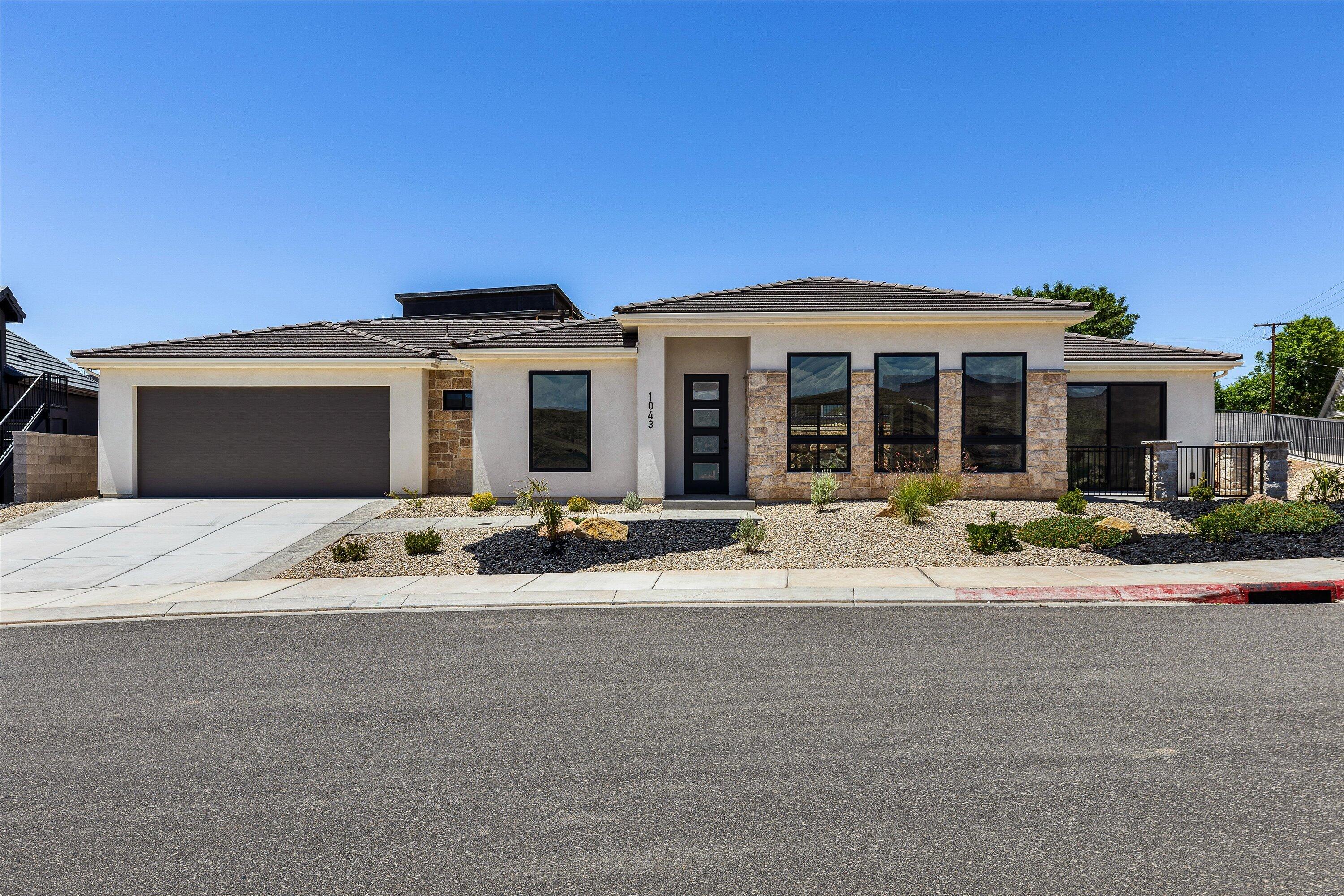 Discover a rare opportunity to own a brand-new home perched on a premier corner lot overlooking the Virgin River, where unobstructed views of the surrounding bluffs and natural landscape will remain protected. Thoughtfully designed to capture the beauty of its setting, this exceptional residence offers expansive windows that fill the home with natural light while showcasing breathtaking scenery from every angle.

The heart of the home is a chef-inspired kitchen featuring a full-size refrigerator paired with a full-size freezer, abundant workspace, and a spacious walk-in pantry designed for both everyday convenience and effortless entertaining. The open-concept living area is anchored by a stunning floor-to-ceiling stone fireplace, creating a warm and inviting focal point for gatherings with family and friends.

Retreat to the private primary suite, where a paved courtyard provides the perfect setting for a peaceful morning tea or evening relaxation while taking in the dramatic bluff views. Two additional bedrooms offer flexibility for guests, family, or a home office.

Outside, professionally completed landscaping enhances the home's curb appeal and creates a seamless connection to the surrounding environment. The oversized double tandem garage accommodates up to four vehicles, offering exceptional storage and versatility for recreational toys, hobbies, or extra parking.

Combining luxury finishes, thoughtful design, and some of the area's most spectacular views, this new construction home delivers an unparalleled lifestyle overlooking the Virgin River.