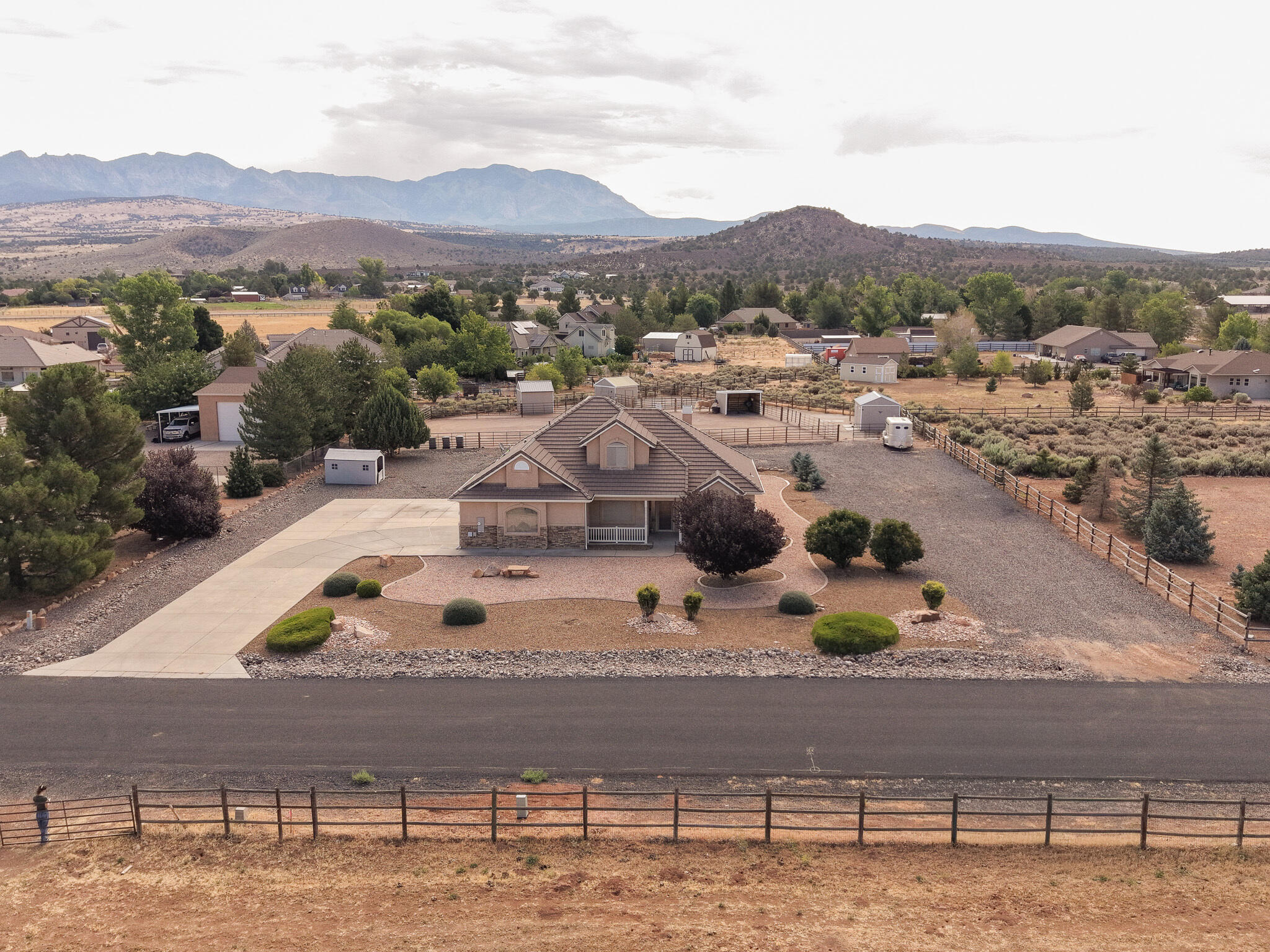 Bring your horses and enjoy the best of Dammeron Valley living on this beautiful 1-acre equestrian property with breathtaking Pine Valley Mountain views. Designed with horse lovers in mind, this property features a large fenced riding arena, multiple paddocks, shelters, outbuildings, and plenty of room for trailers, RVs, and all your toys. Inside, you'll find a well-designed 3-bedroom, 2.5-bath home with the primary suite conveniently located on the main level, along with a dedicated office and guest half bath. The spacious kitchen flows into the dining and living areas, creating an open great room perfect for gathering. Relax on the covered patio and enjoy peaceful country living just minutes from St. George, with endless opportunities for horseback riding, hiking, and outdoor recreation right outside your door.