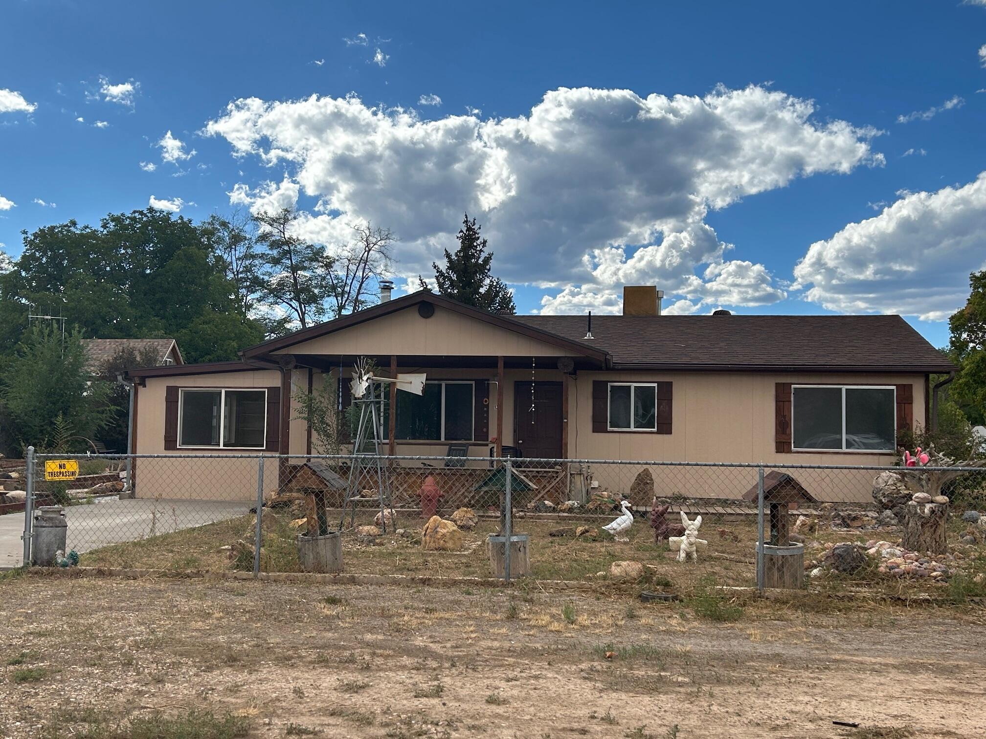 Great country home on a large .62 Acre lot in the heart of the Grand Staircase Escalante Nat'l Monument. Open concept with spacious kitchen, and a great room with a nice wood stove for those chilly winter nights after enjoying the dark skies. New flooring, lots of natural light and a large bonus room with separate entrance. The primary bedroom has a large den/office that could be converted to an additional bathroom or walk-in closet/ storage, with access to the back covered patio.  Lots of possibilities for this well kept home with a relaxing front porch to enjoy the views of the Escalante Canyons. Bring the chickens and horses. Large workshop with power and tons of space for RV parking. Lots of outbuildings & room to roam.