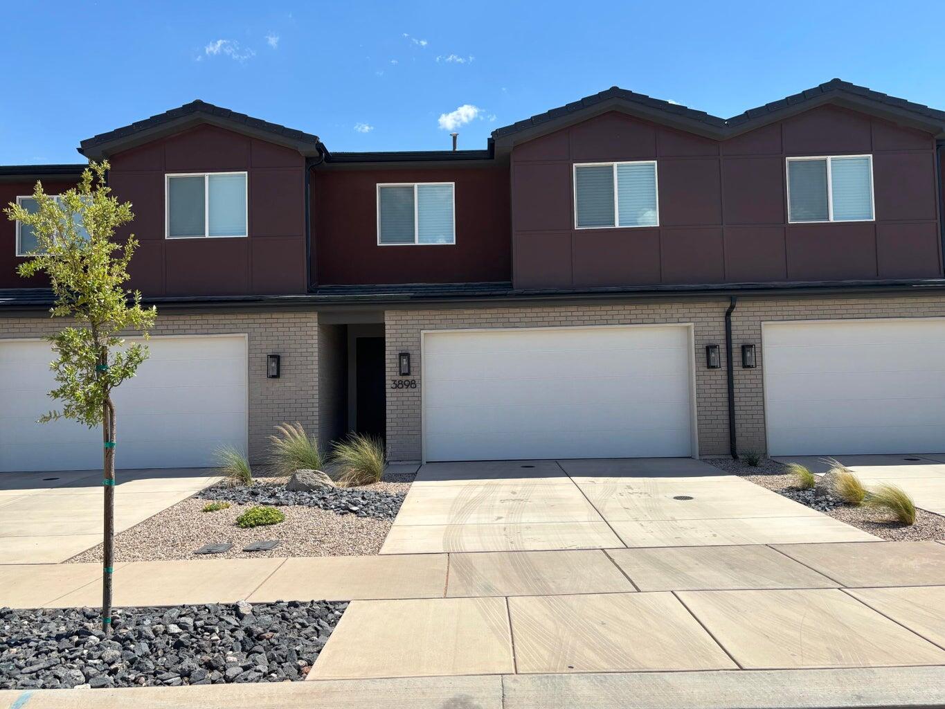 See yourself in this like-new townhome in the coveted Coral Canyon community! This single-owner unit features an open-concept main floor with a bright living room, half bath, and a stylish kitchen with quartz counters, soft-close cabinets, and a spacious island with bar seating. With no backyard neighbors, enjoy the serene view from the enclosed patio overlooking the community walking path. Upstairs offers a welcoming primary suite with dual vanities, a large glass shower, and a walk-in closet, plus a laundry closet, full bath, and two additional bedrooms.