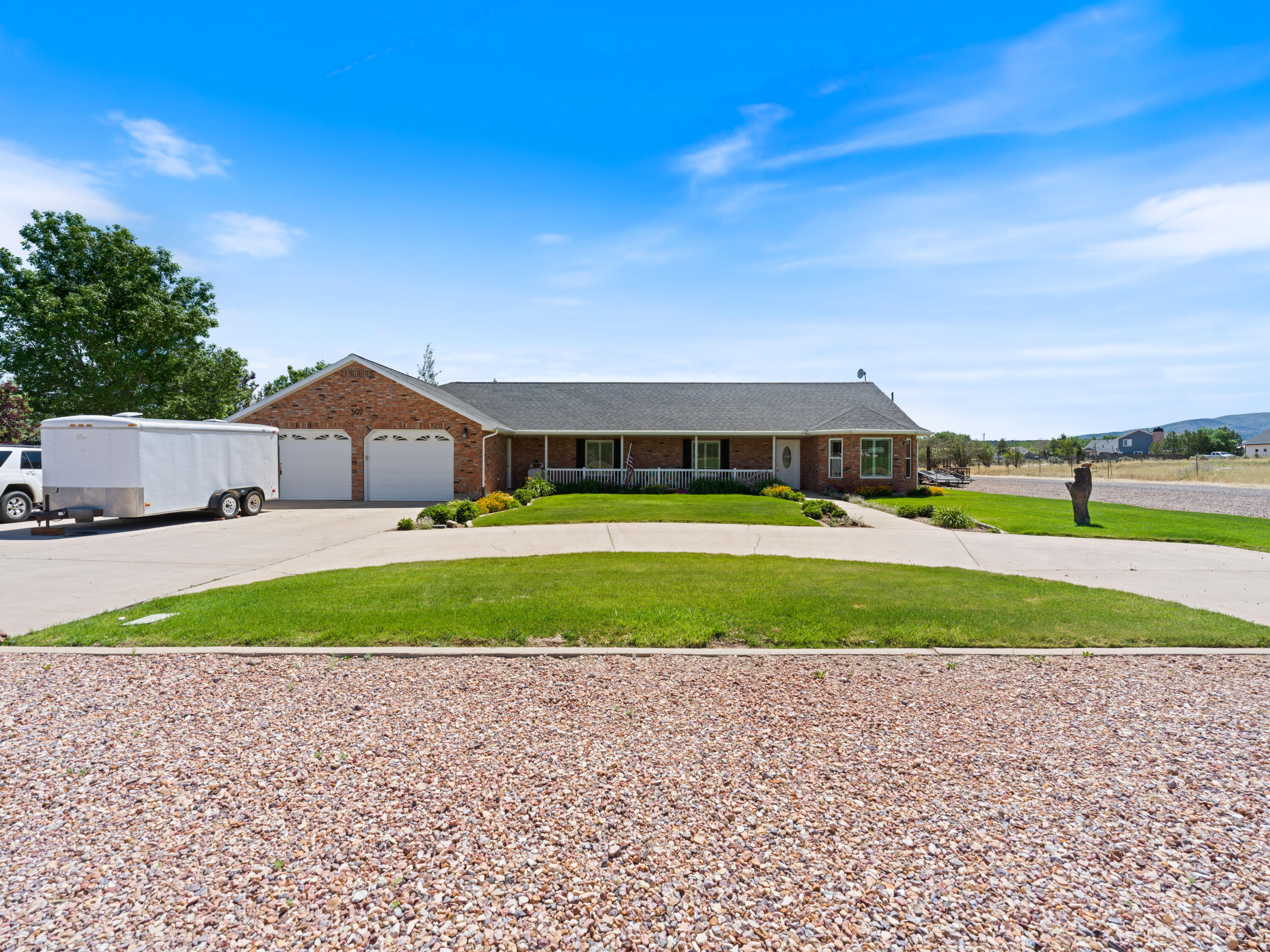 Views, Space, and Small-Town Living in Enterprise  |  Set on a large corner lot in the heart of Enterprise, this well-cared-for home offers the space, views, and flexibility that draw people to rural Southern Utah in the first place. The welcoming front porch is the perfect place to take in the surrounding scenery, while inside you'll find comfortable living spaces, a gathering-friendly kitchen, and beautiful built-ins that add both character and function. With 3 bedrooms plus a den that could easily serve as a fourth bedroom, there's plenty of room to adapt the home to your needs.
Recent improvements include newer windows, flooring, and roof, helping make this home move-in ready while preserving the warmth and charm that make it feel like home. Outside, the nearly 0.6-acre lot opens the door to all kinds of possibilities. Whether you're dreaming of a garden, space for animals, an ADU, or simply room to spread out, you'll have the space to make it happen. The huge backyard patio, partially covered for shade and comfort, creates an ideal spot for gatherings, barbecues, and quiet evenings enjoying the view. If you've been looking for a property with elbow room, beautiful surroundings, and the slower pace that makes Enterprise special, this one deserves a closer look.